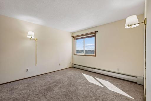 Bedroom one is spacious and has the convenience of wall-mounted lights with shades.