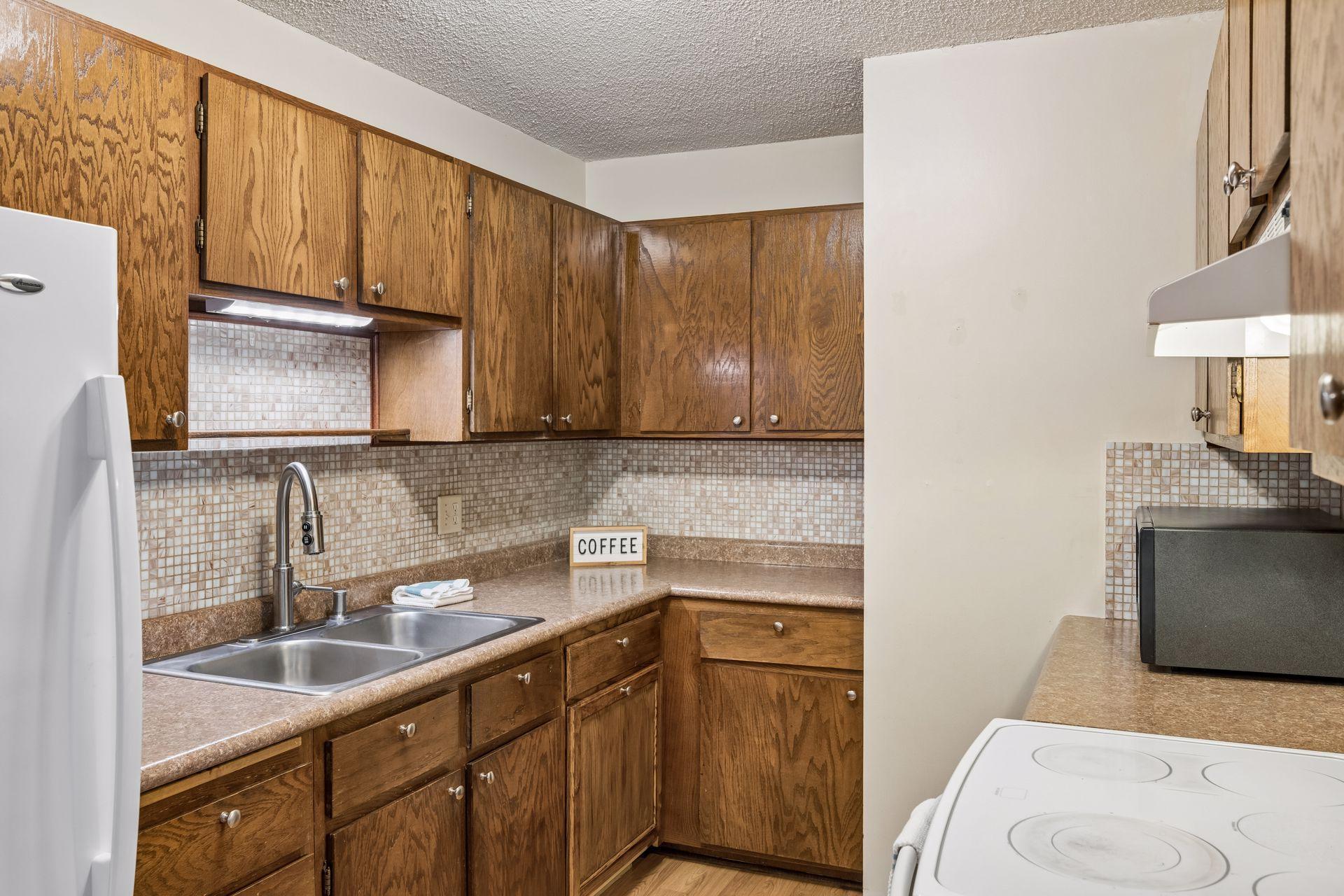 Natural Wood cabinets with decorative tile backsplash!