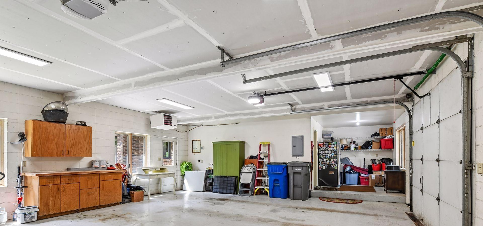 This insulated and heated garage features plenty of storage and epoxied flooring.