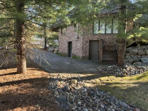 The Side paved parking area is located conveniently next to the lower level workshop room and the dry storage room near the deck
