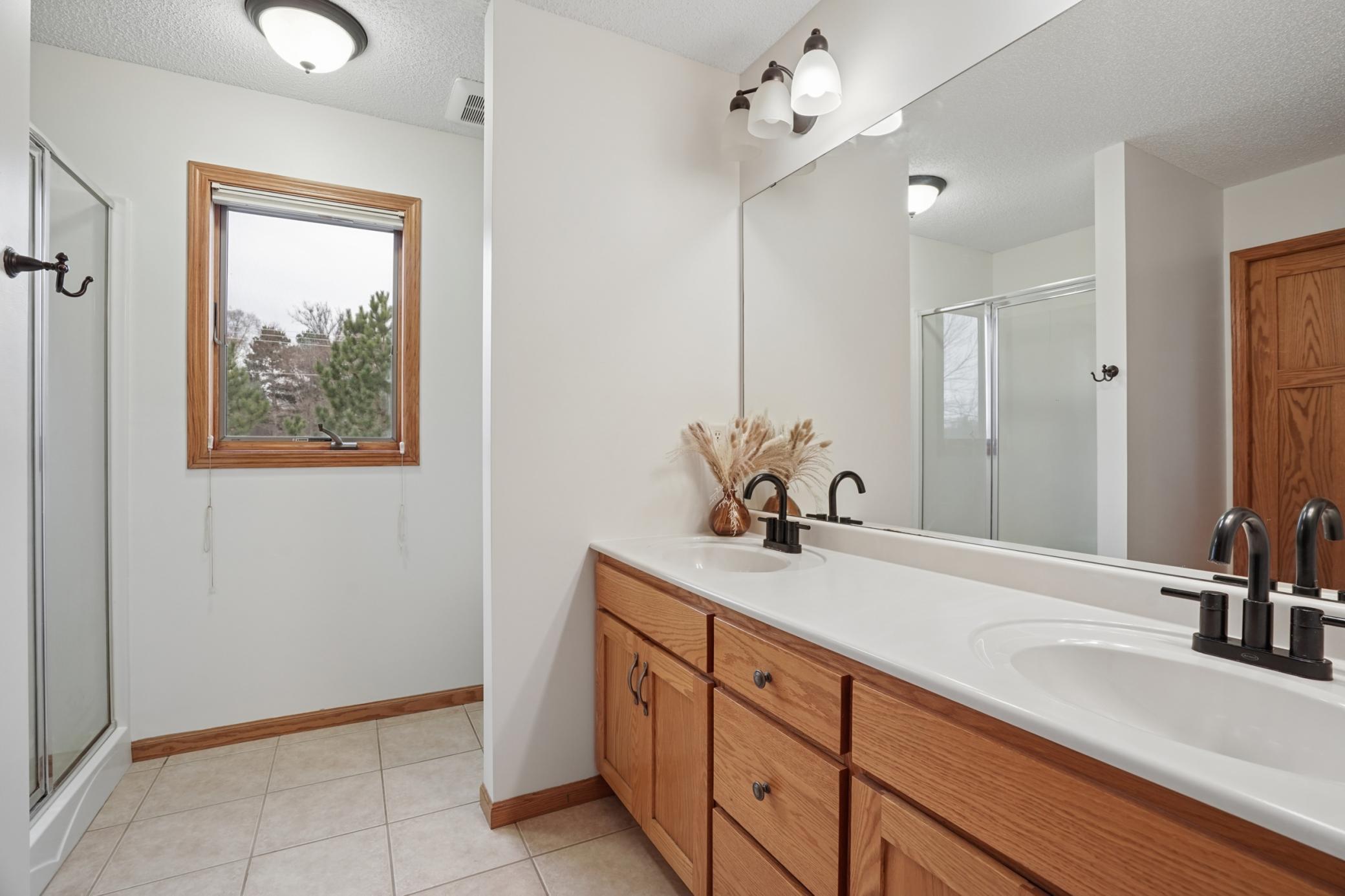 Primary suite includes a 3/4 bath w/ dual sinks and a generous sized walk-in closet