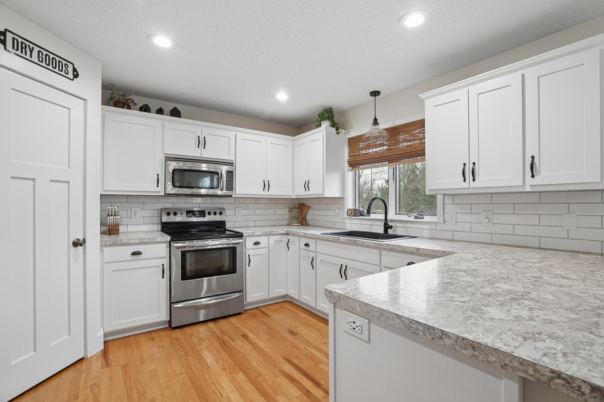 Be ready to fall in LOVE with this kitchen! SS appliances, shaker style cabinetry, hardwood floors, recessed lighting, and a nice pantry!