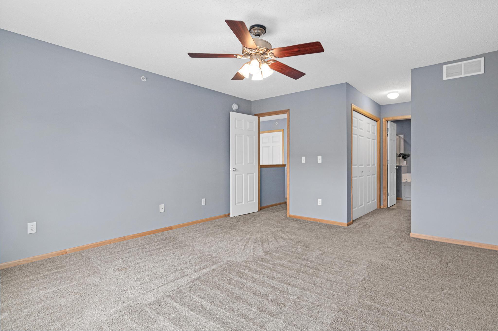 Primary bedroom with private full bath and walk-in closet