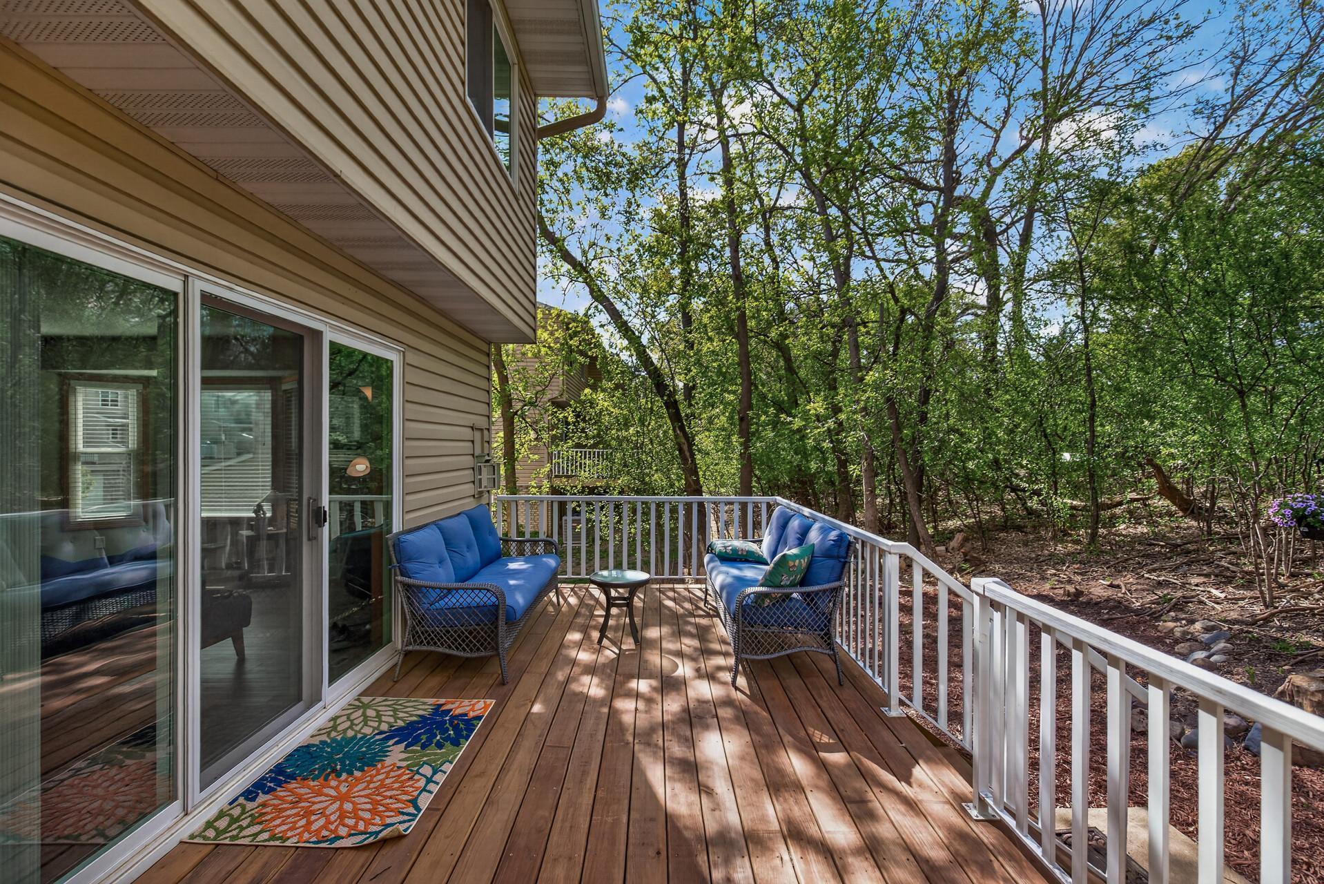 Three panel door that leads to deck and green space.