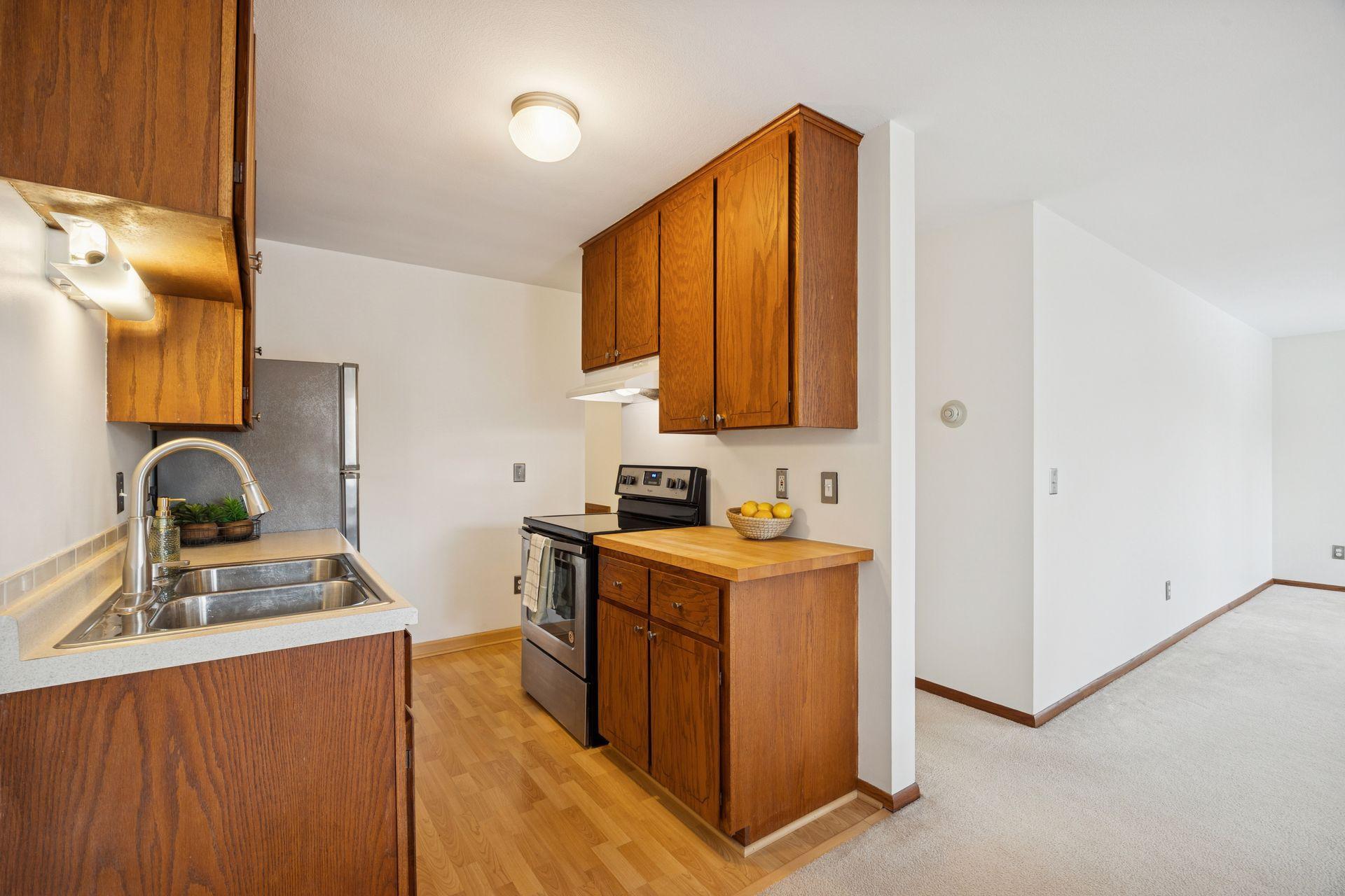 This kitchen shines with butcher block counter and stainless steel appliances, blending charm and convenience for everyday cooking and entertaining.