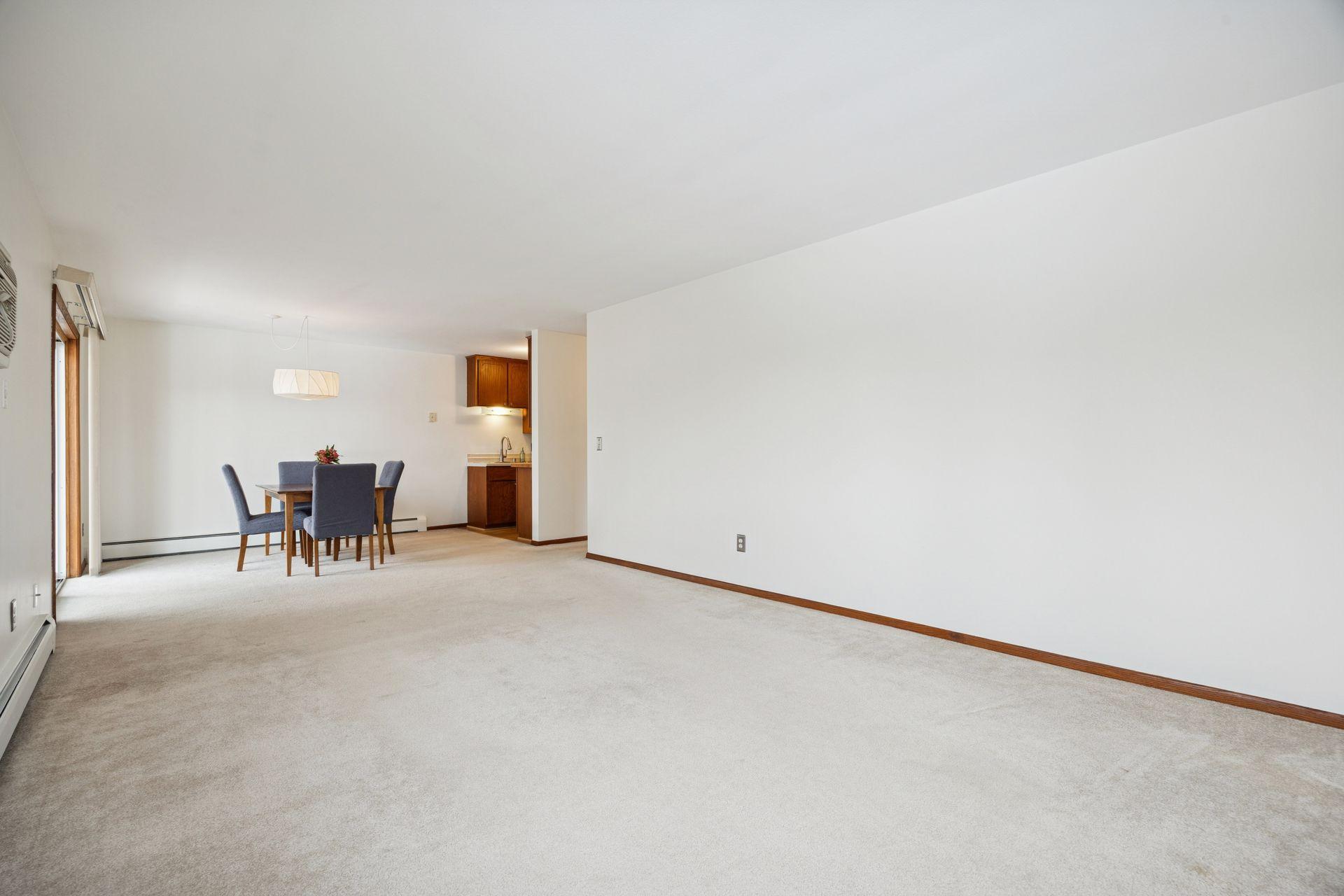 This oversized living room flows seamlessly into the dining area, creating an open, airy space that feels made for gatherings (and everyday comfort).