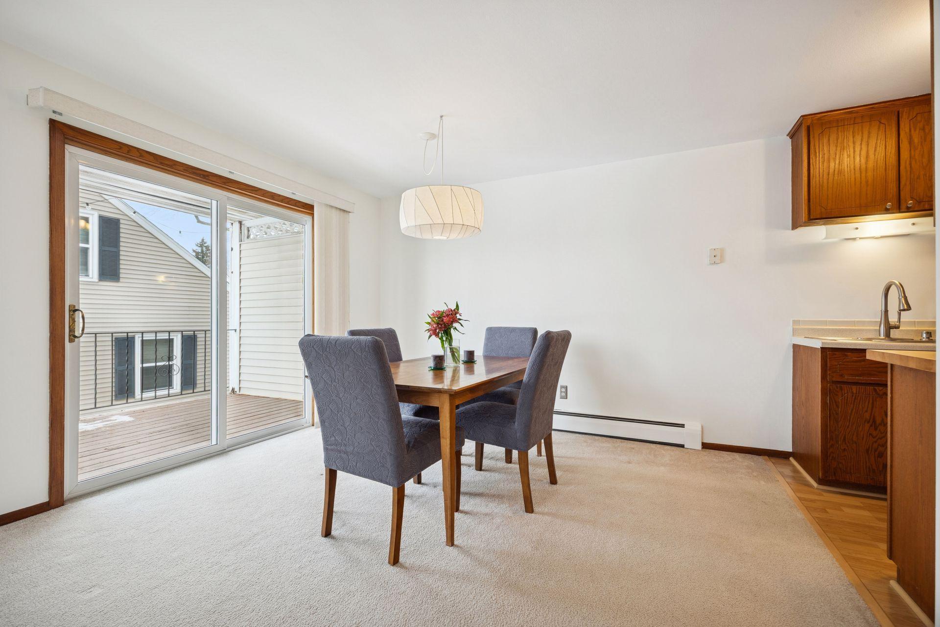 Dining room with sliding glass doors that open to a large deck. Perfect for indoor/outdoor entertaining, morning coffee, and summer dinners outside.