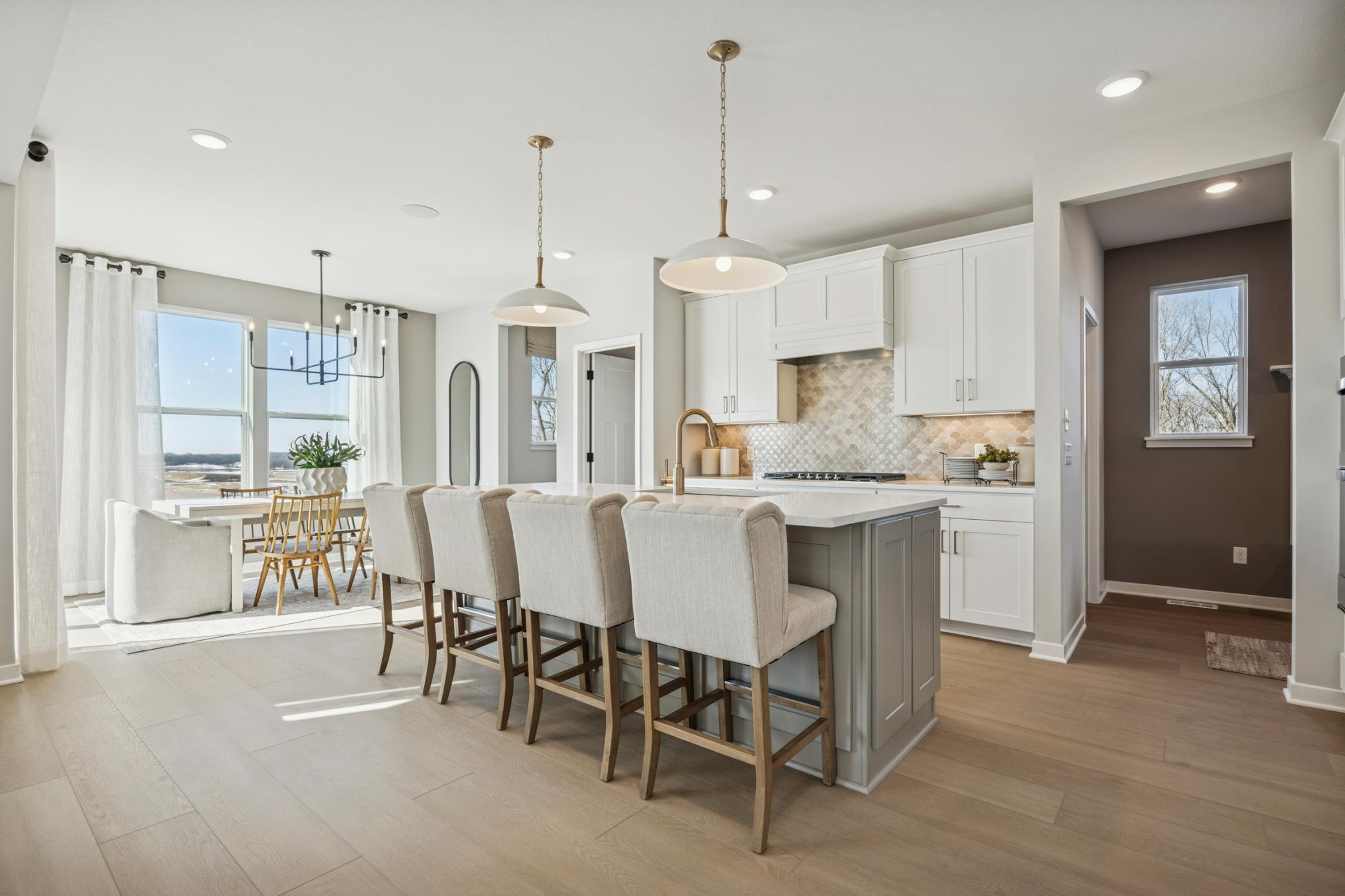 Expansive island with quartz surface offers additional prep space, bar seating, and a stylish centerpiece to your new kitchen.