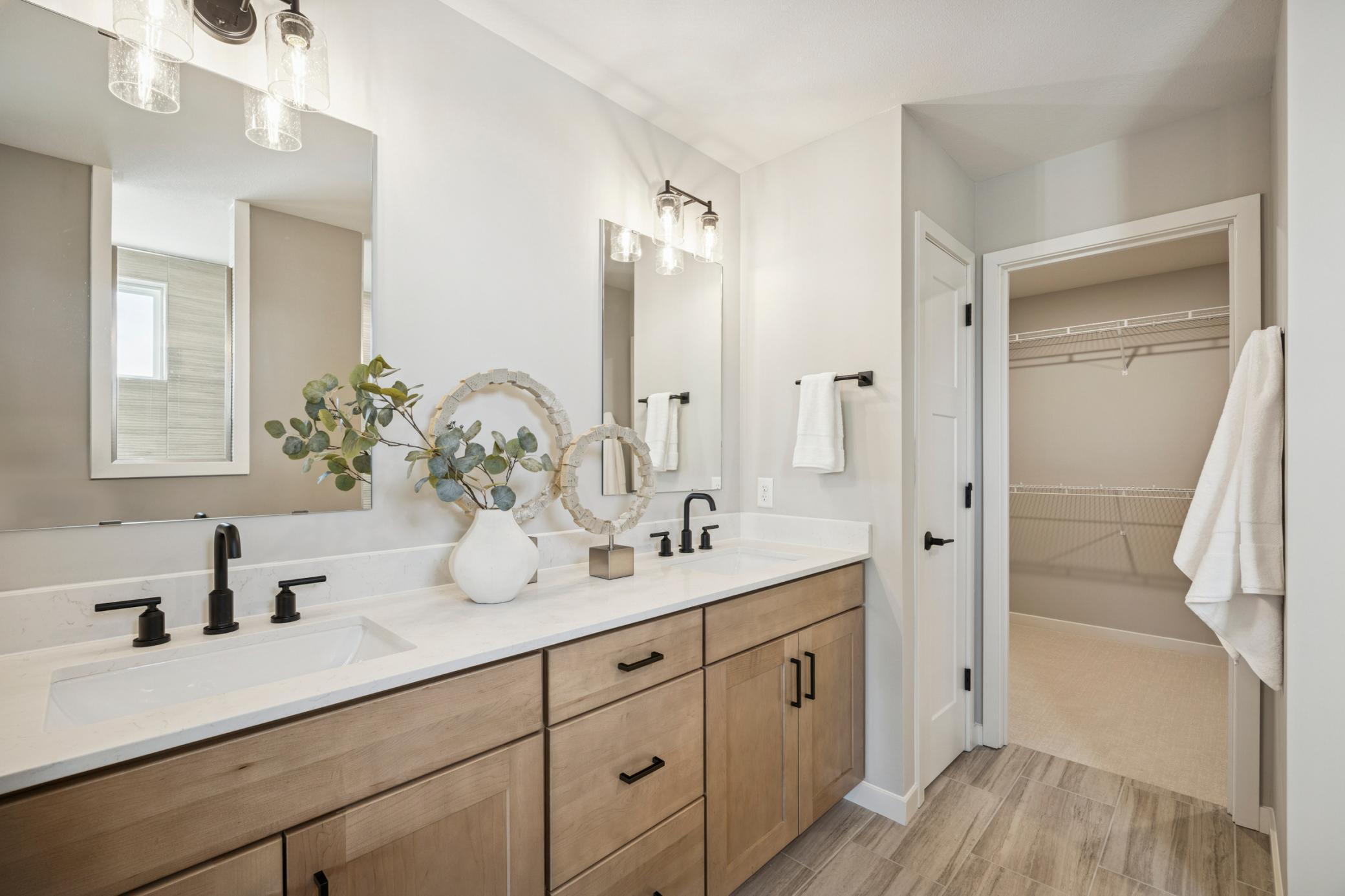 Double vanity with sleek countertops and ample storage provides both function and style—perfect for shared use while maintaining personal space.