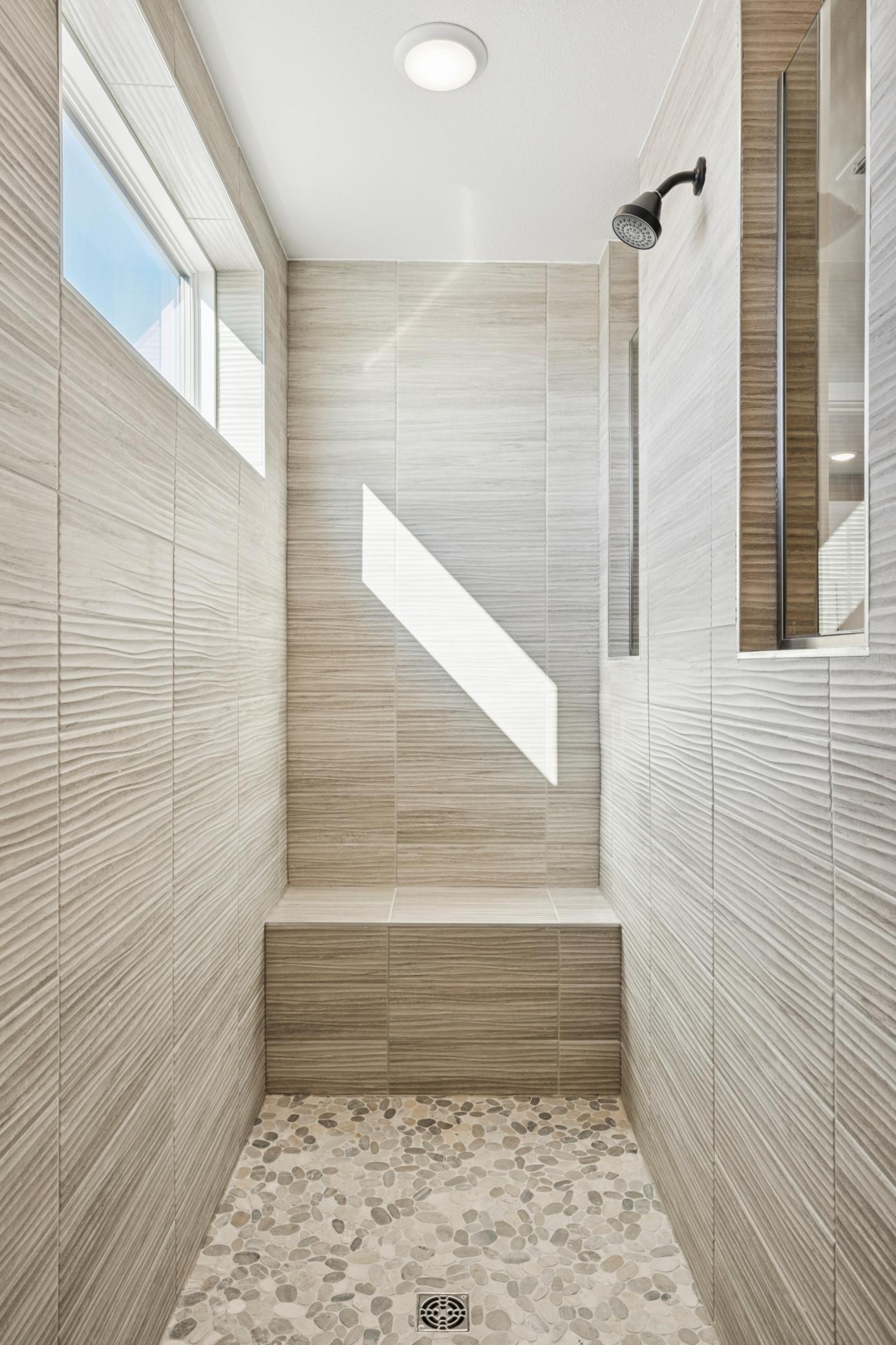 Elegant tilework and modern fixtures elevate the walk-in shower, offering a sleek, spa-inspired design that feels both timeless and on-trend.