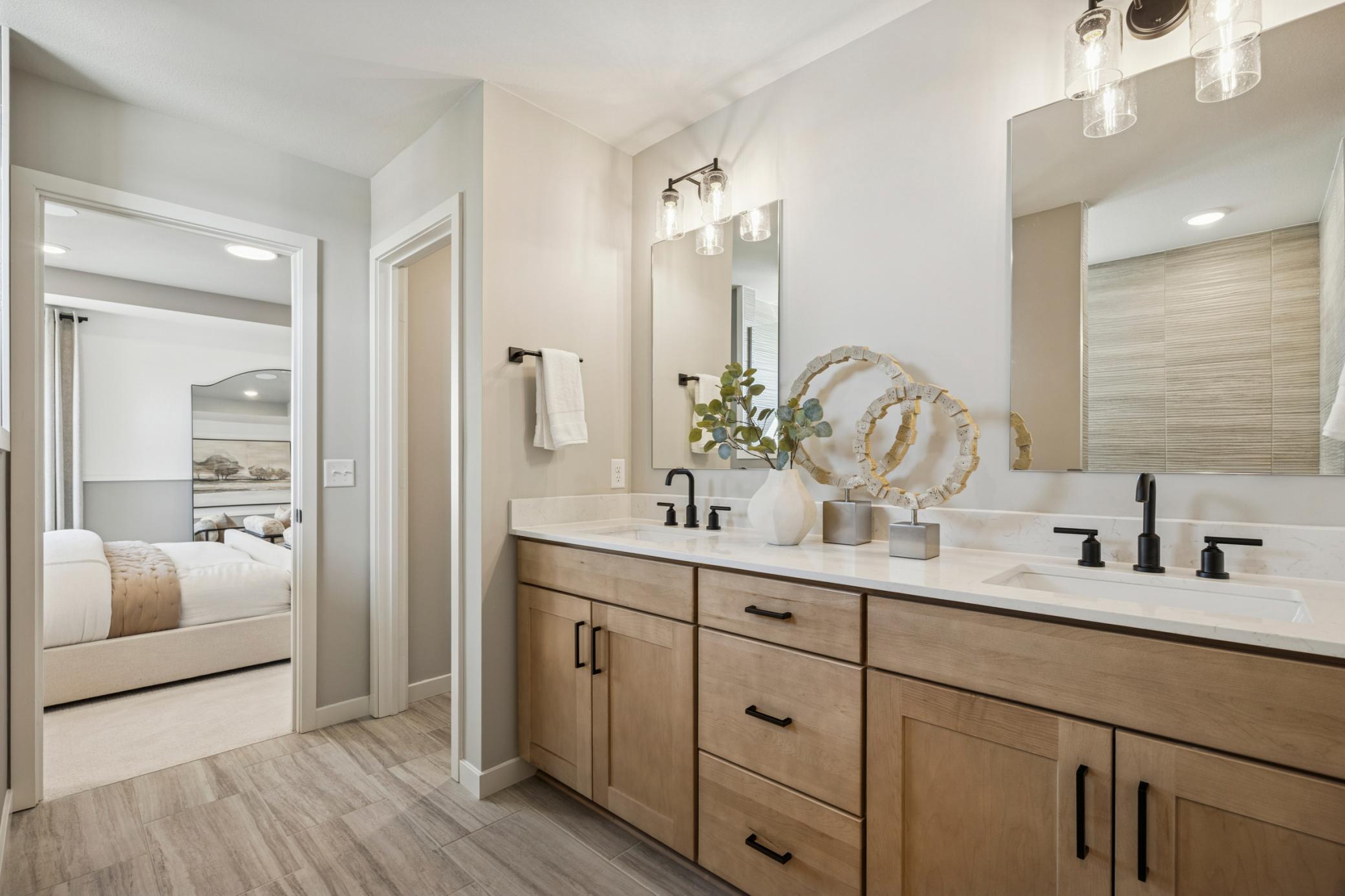 Generous vanity with ample counter space and under-sink storage provides both practicality and style, ideal for everyday routines.