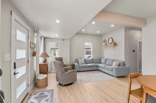 The living room complete with an exposed beam and recessed lighting—with abundant natural light.