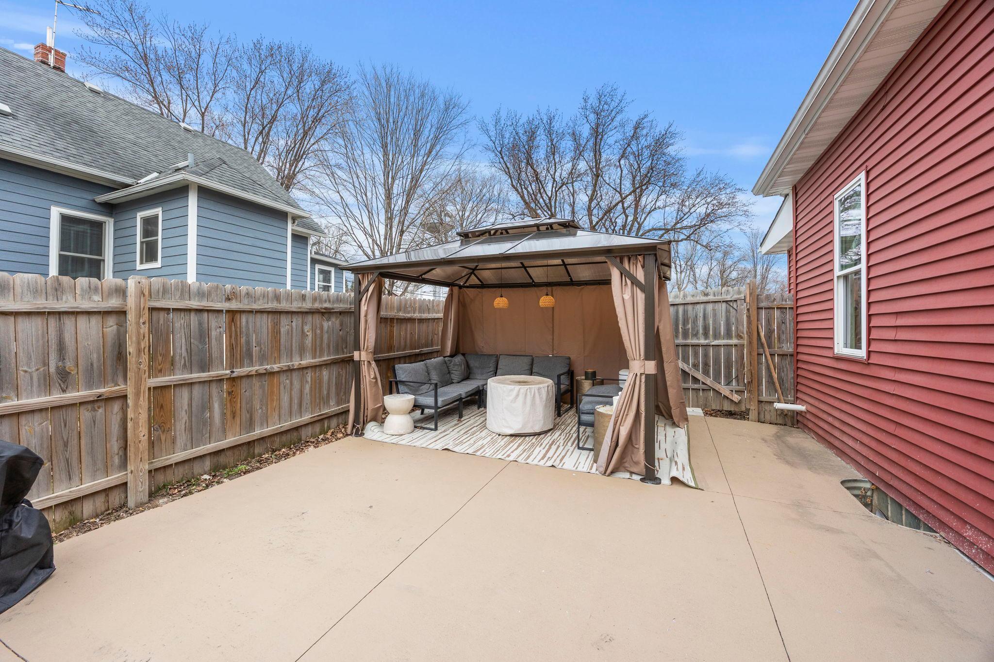 The oversized driveway and extended concrete slab that continues into the backyard—perfect for a spacious patio, entertaining area, or additional parking.
