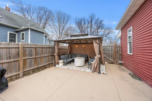 The oversized driveway and extended concrete slab that continues into the backyard—perfect for a spacious patio, entertaining area, or additional parking.