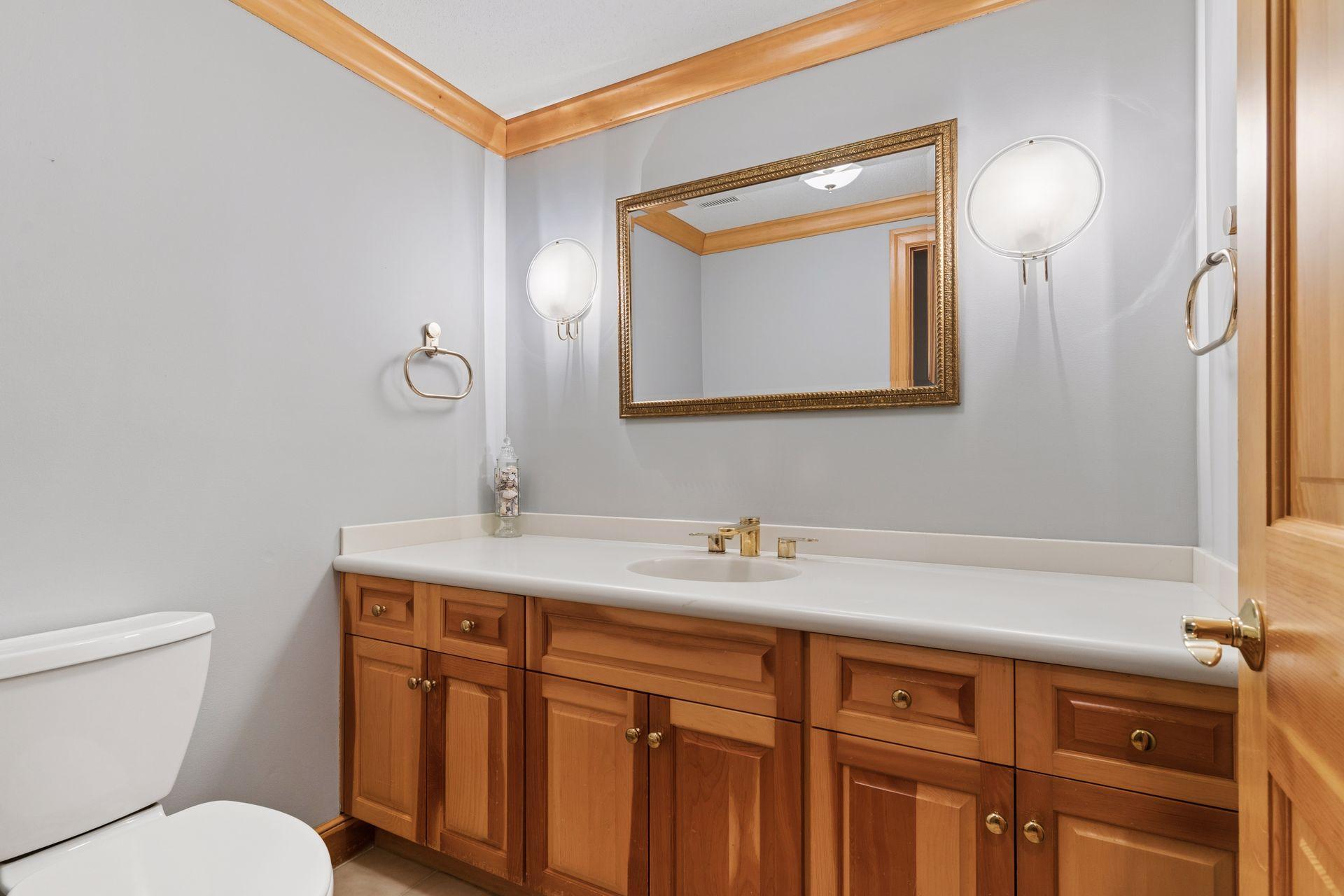 The main level Powder Room features custom cabinetry and crown molding.