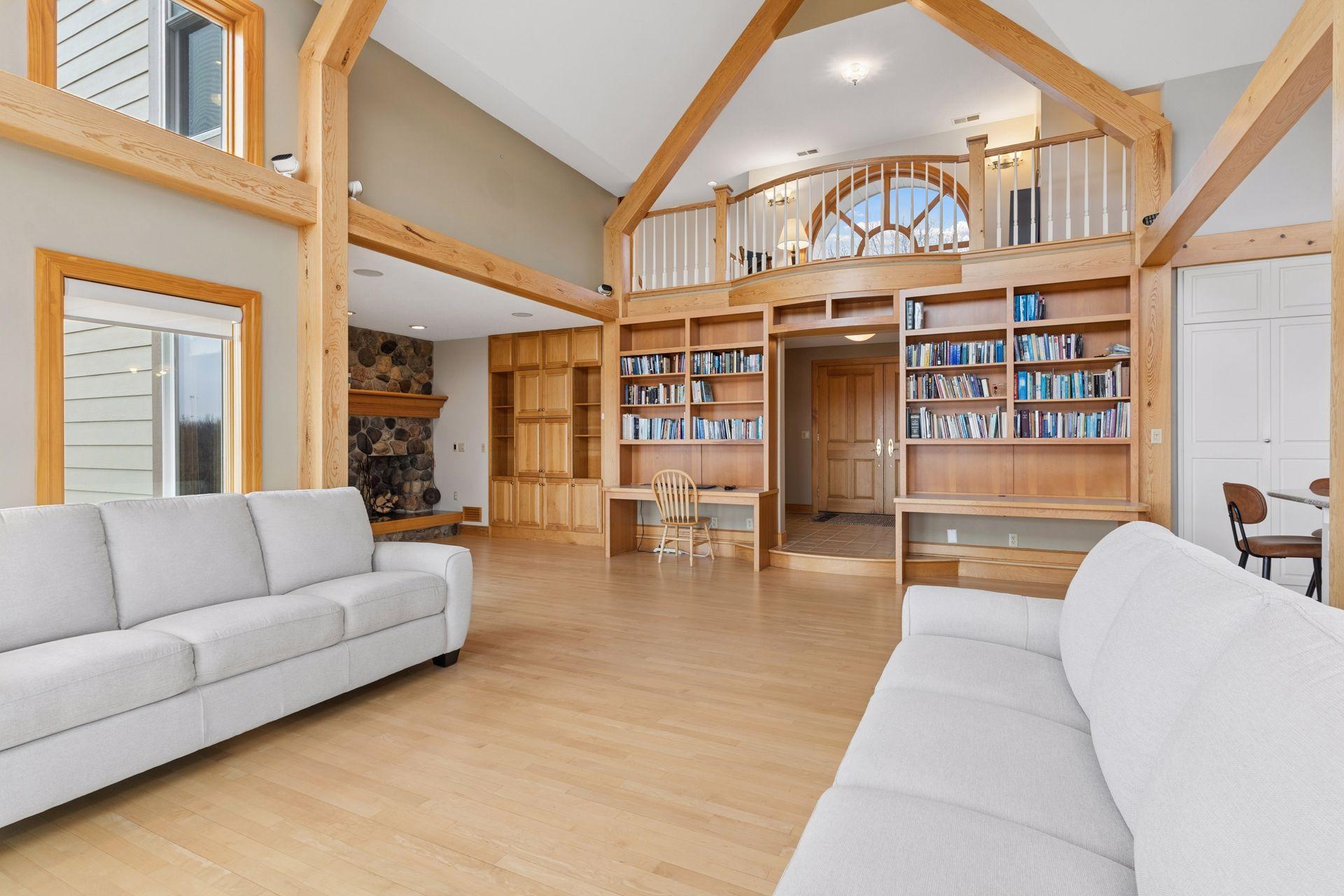 Walls of built-in bookcases and custom cabinetry line the walls.