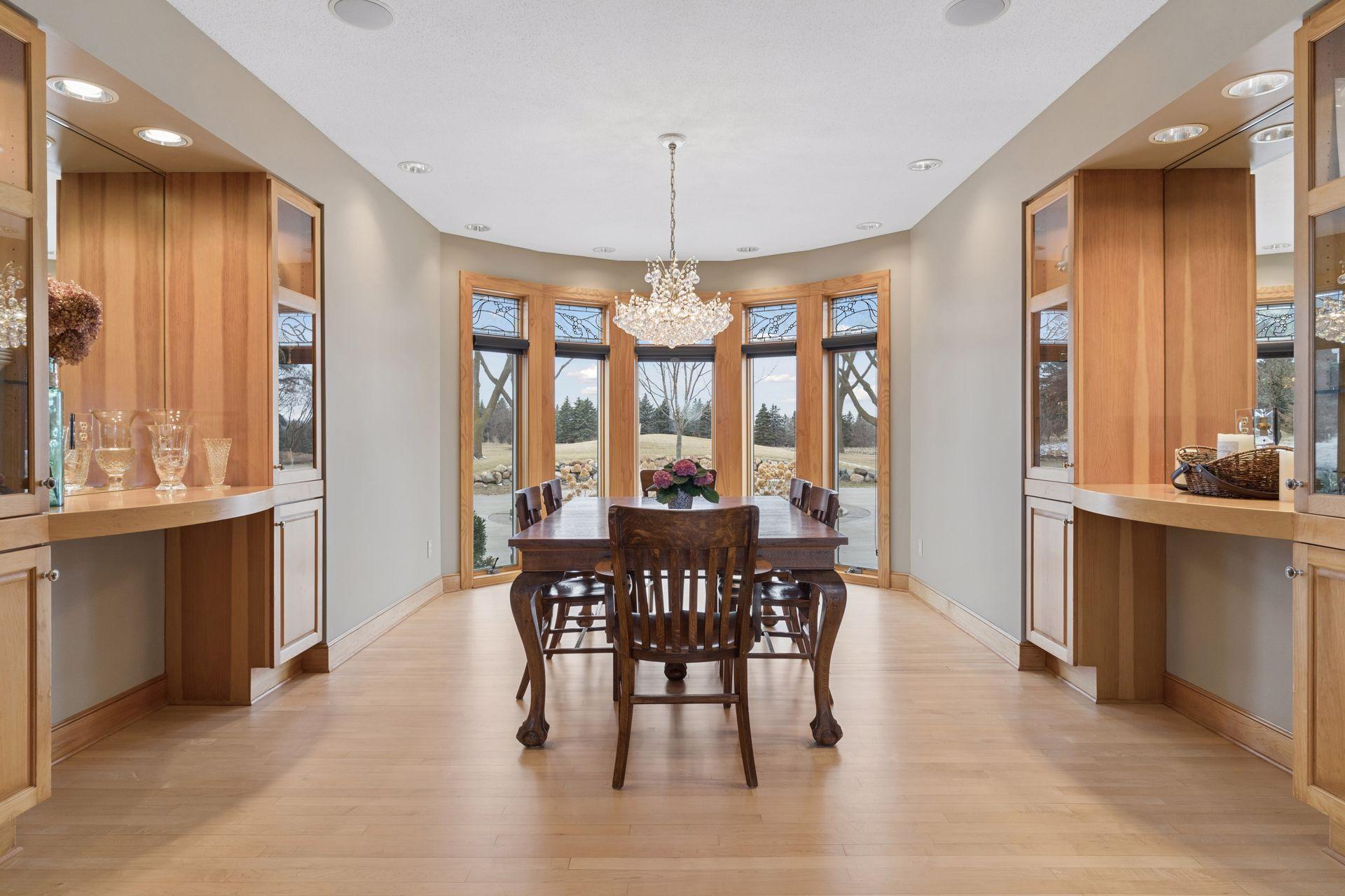 For special occasions, the Formal Dining Room is ready for you to host! The space features two built-in buffets with glass-front cabinetry and a gorgeous light fixture.