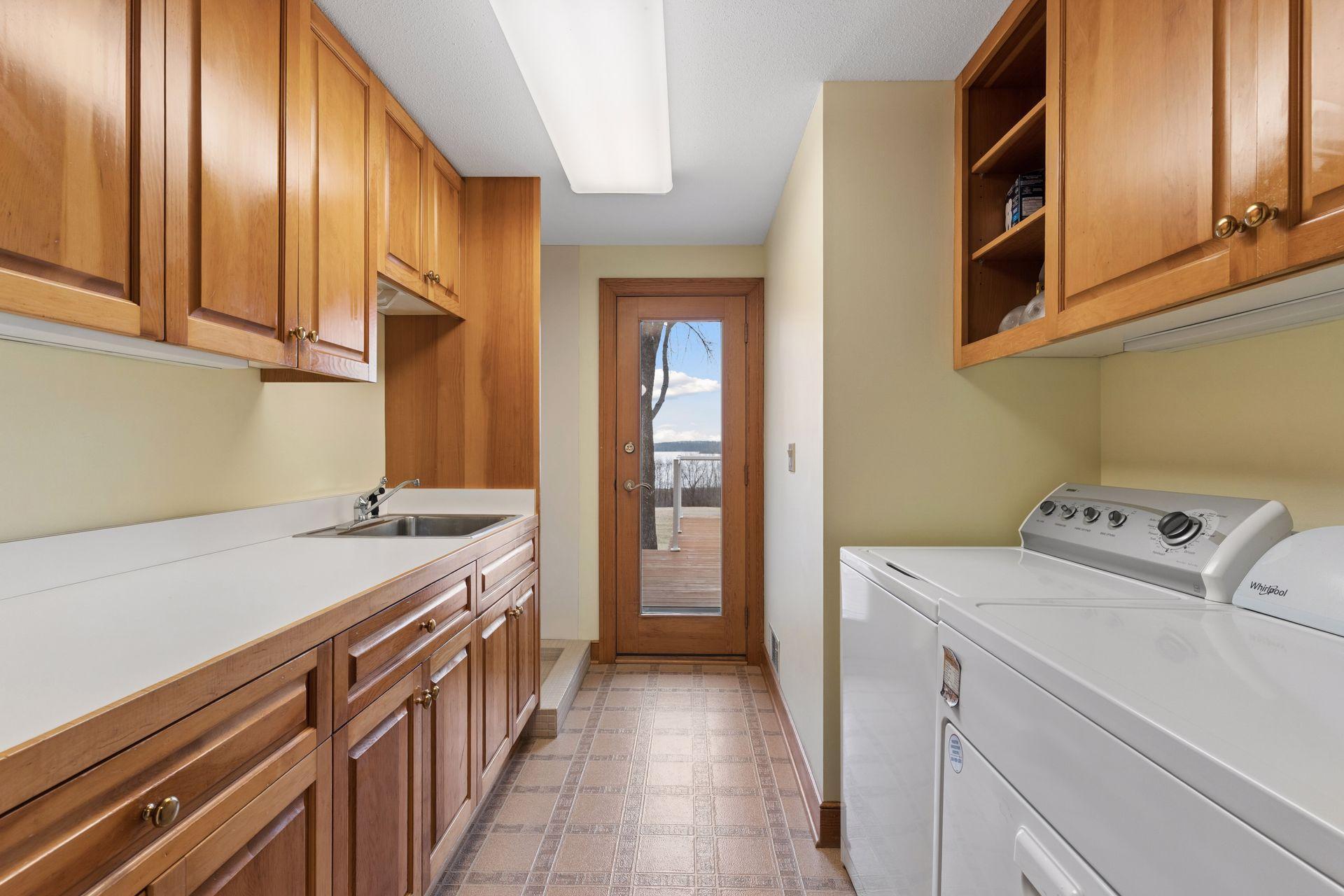 This laundry room makes doing this chore a breeze with extensive cabinetry and a large folding counter.