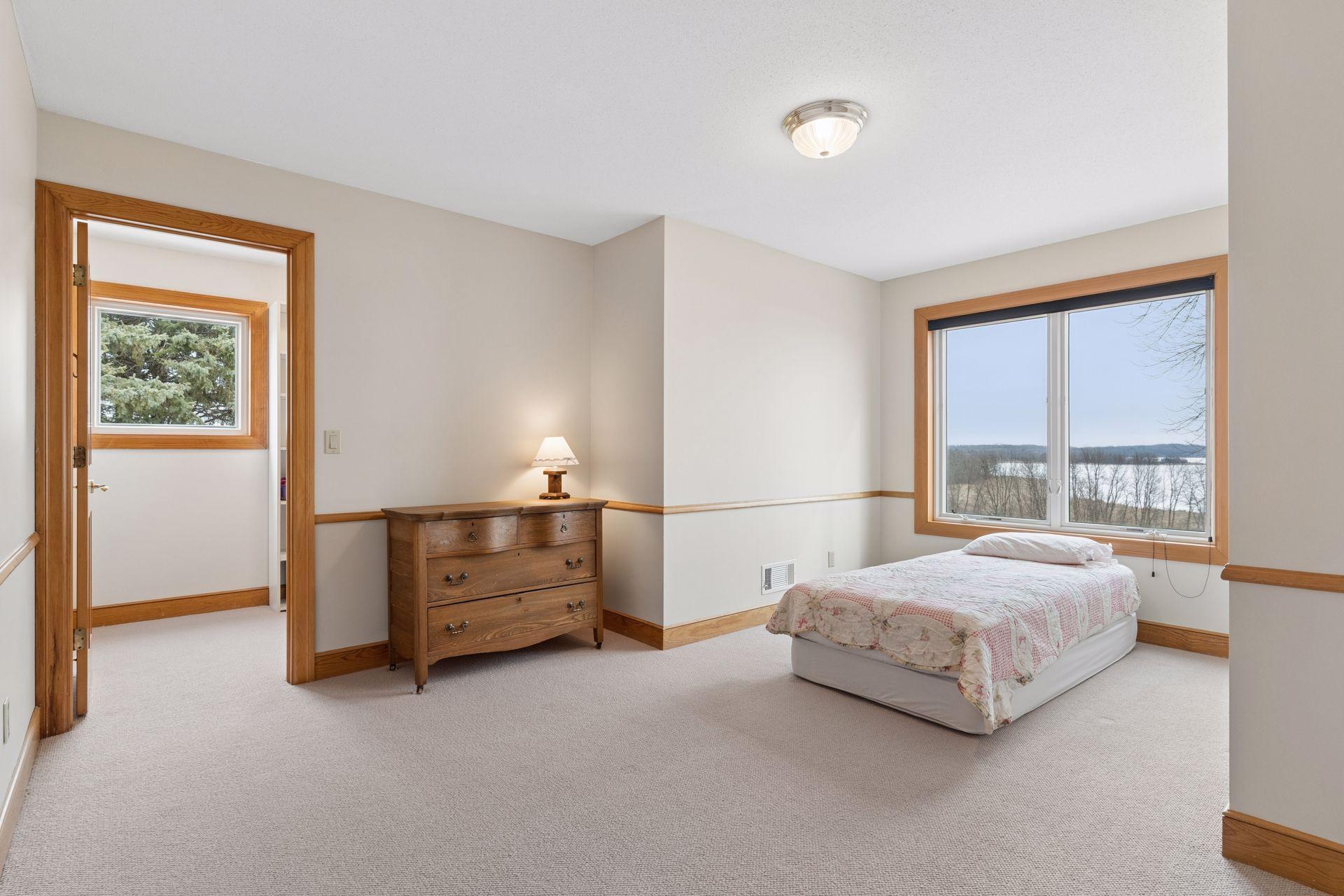The third junior bedroom sits at the end of the hall and overlooks the backyard and lake.