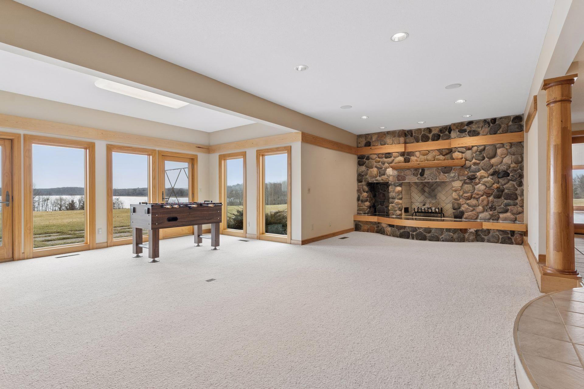 This lower level was designed for fun! With a second wood burning fireplace and space for your game table, there is plenty of room to spread out.