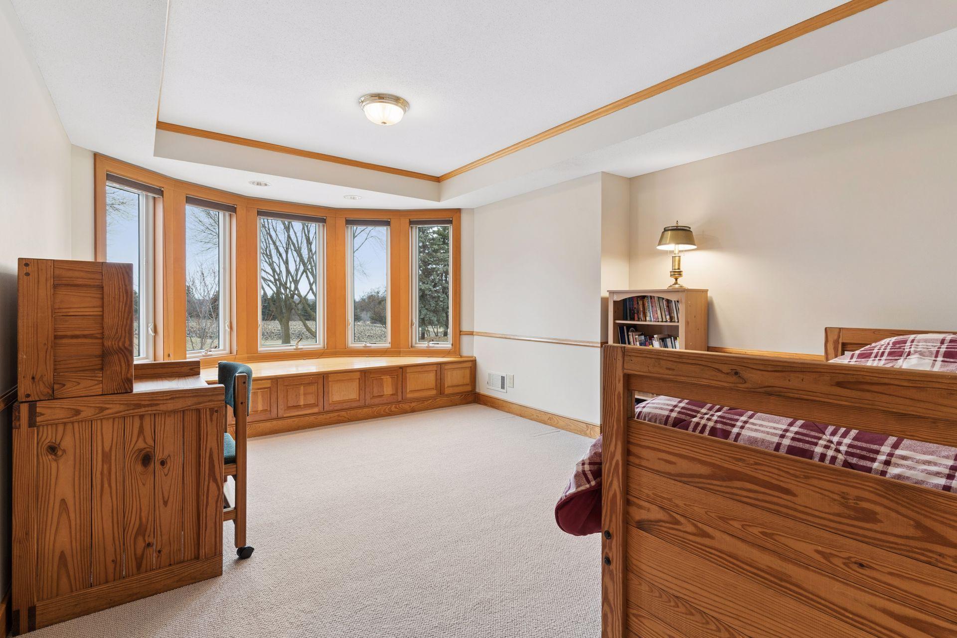 In addition to the primary suite, the upper level houses three junior bedrooms.