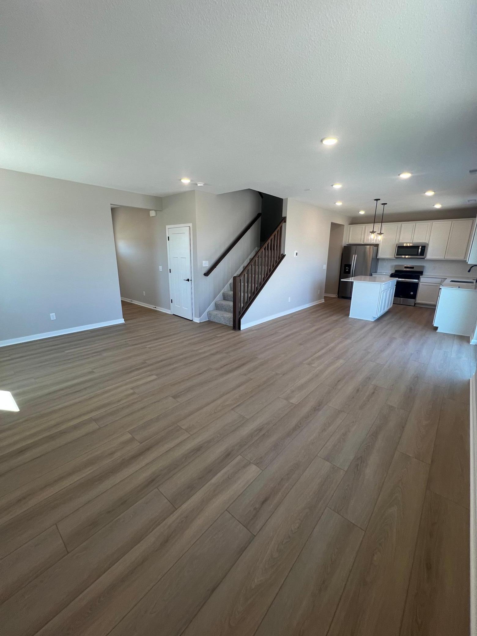 Hard surface flooring in the gathering room, dining and kitchen