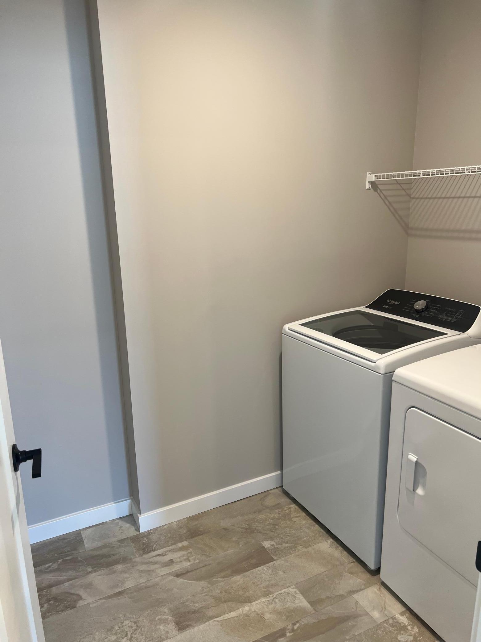 Durable flooring and bright lighting create a clean, functional laundry room