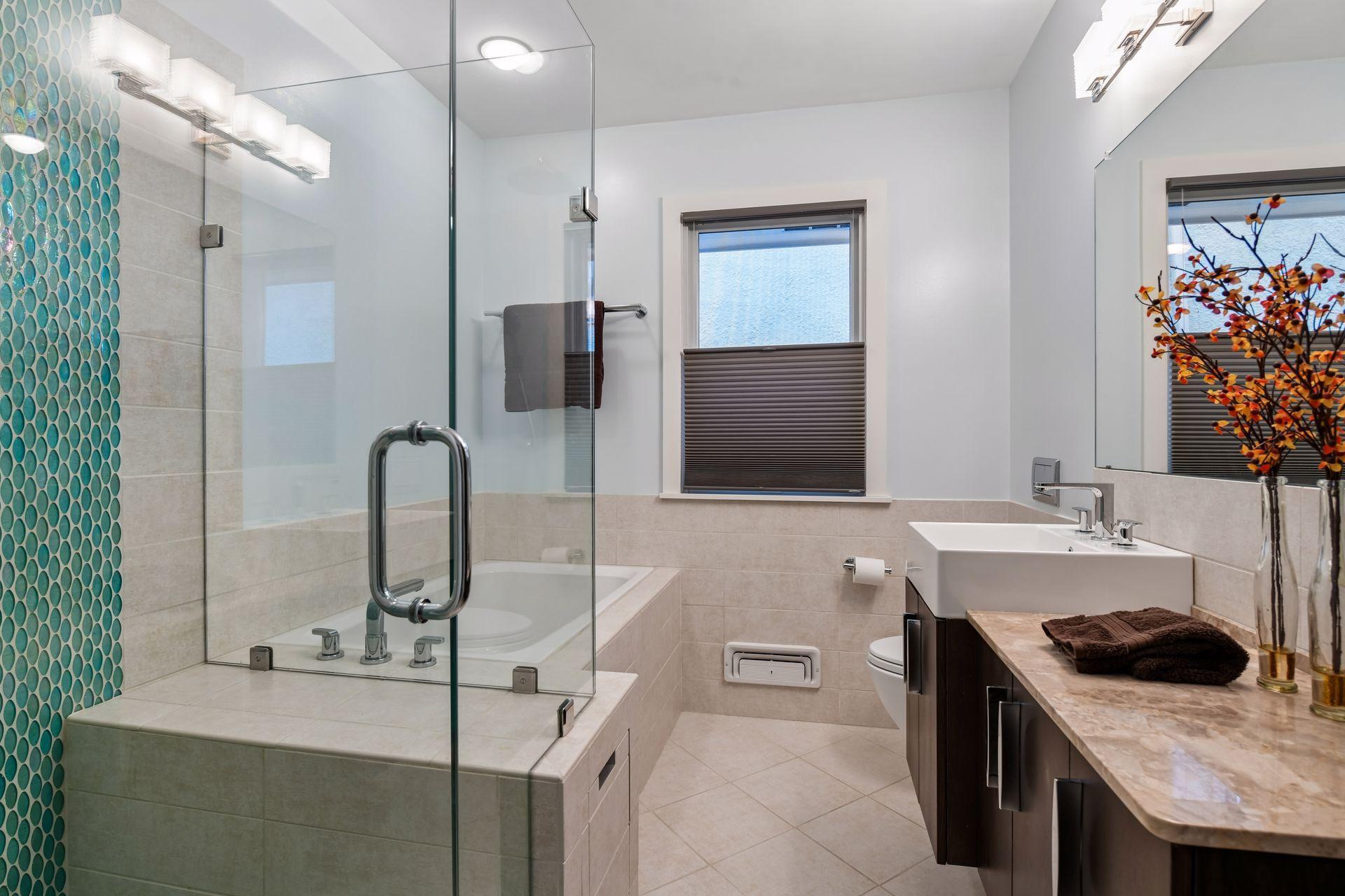 WOW! Check out this gorgeous main floor bathroom with large walk-in shower, relaxing soaking tub, floating vanity with plenty of counter space/storage.