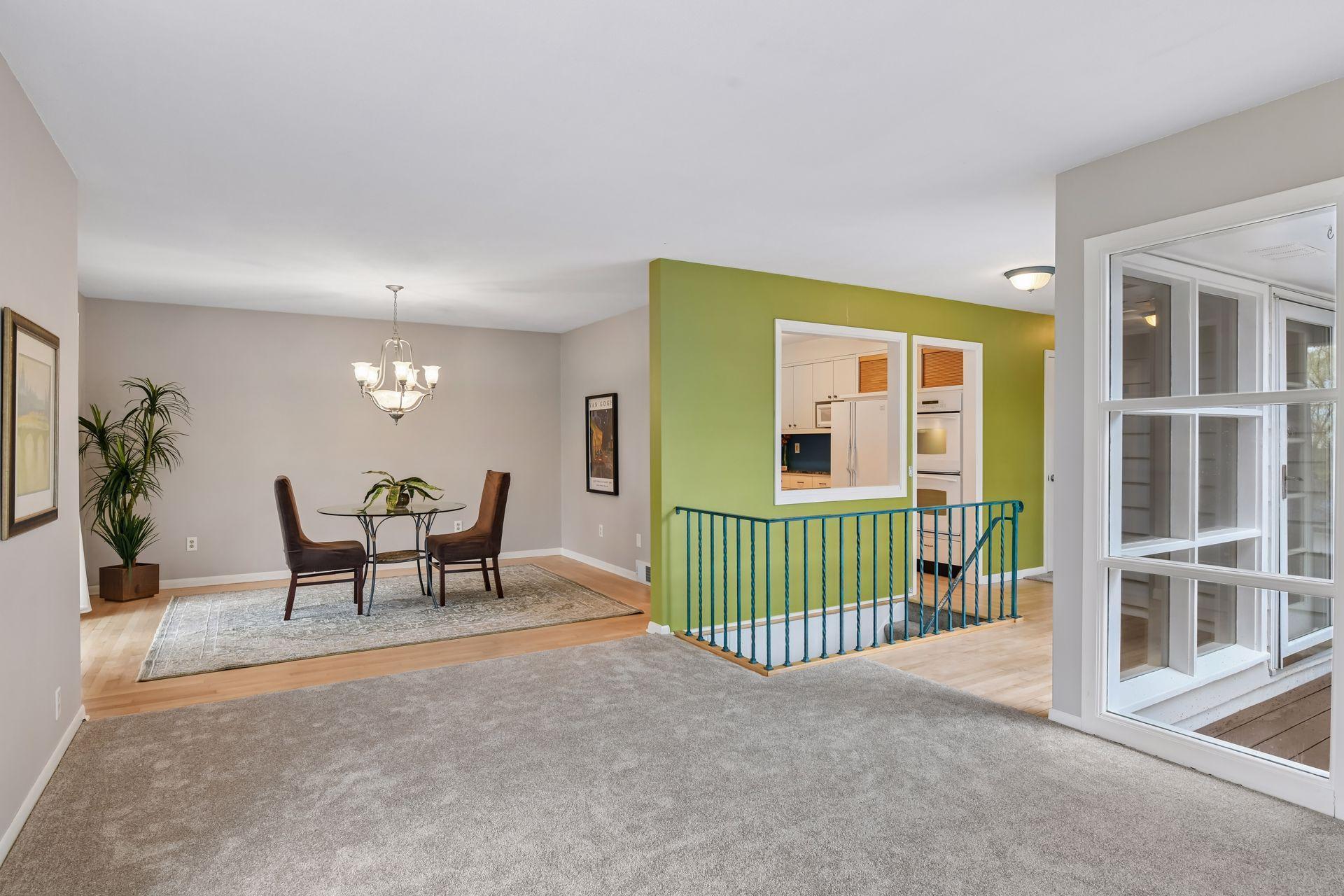 The main living area is spacious and bright with open sight lines and a fresh, neutral decor with tasteful pops of color.