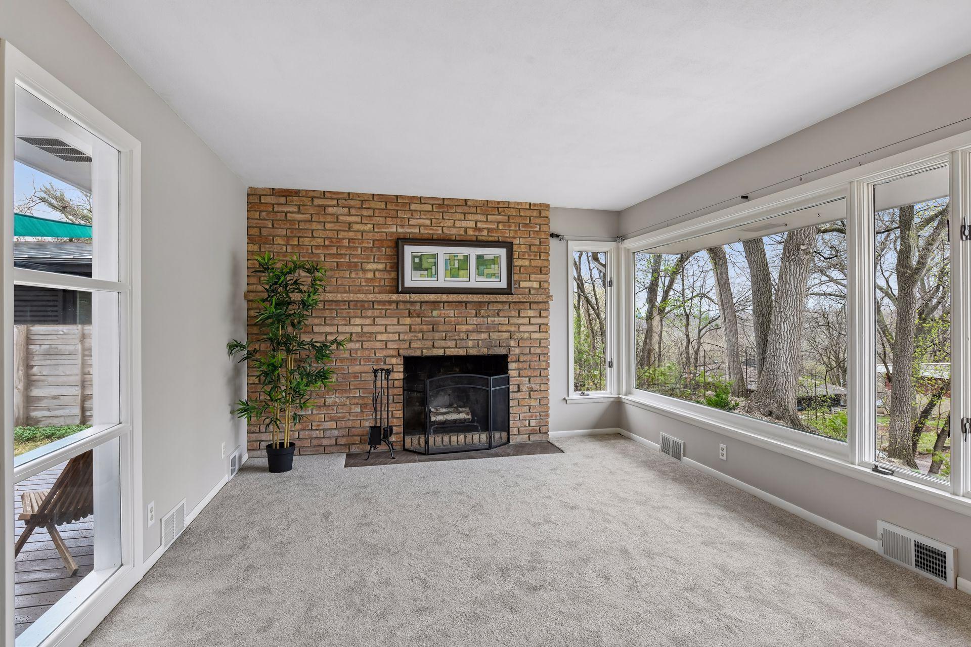 Expansive wooded views from the oversized windows give the lofted living areas a 'treehouse' feel. Enjoy the cozy brick fireplace and newer plush carpeting.