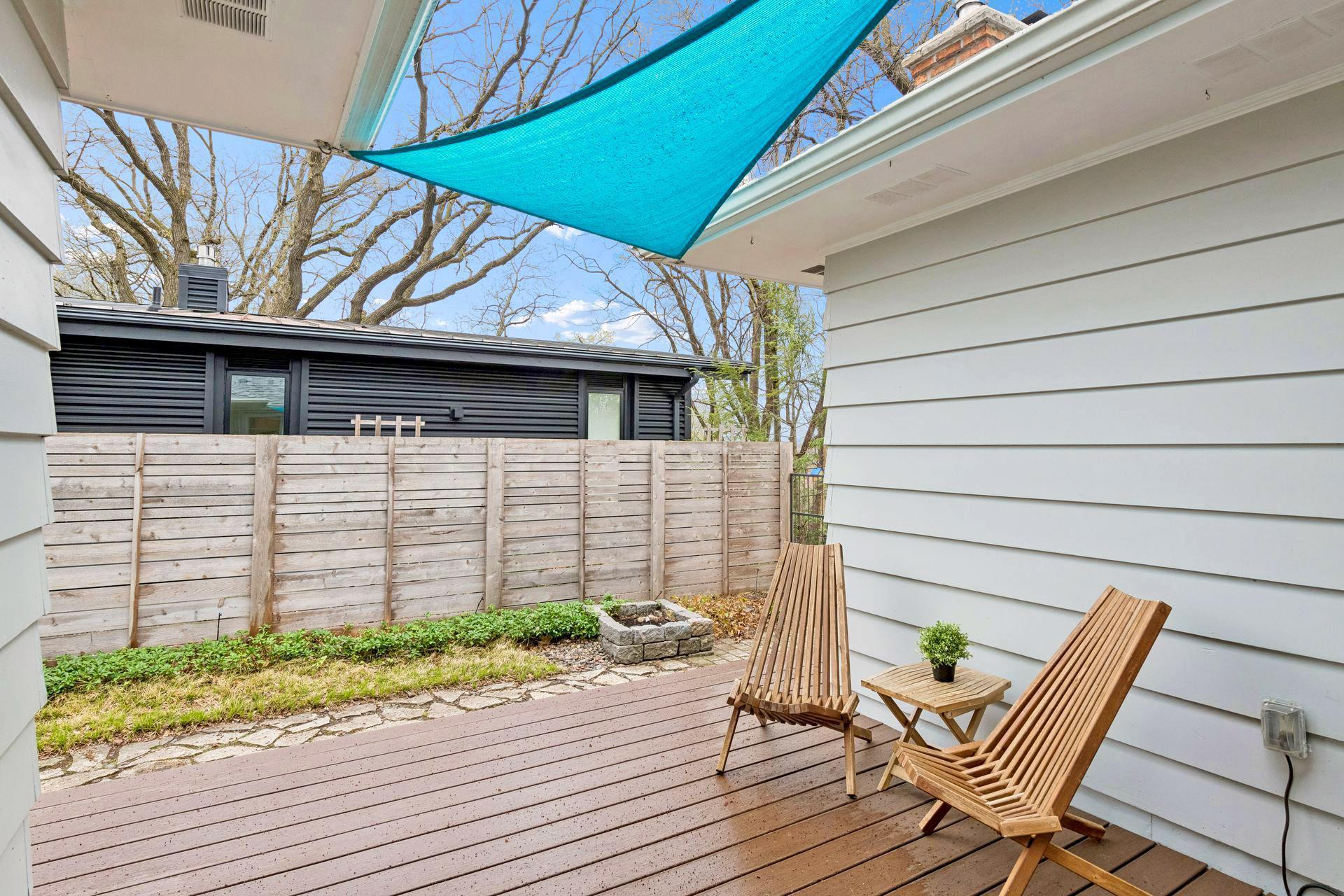 The side deck area is private and flanked by greenery and perennial gardens.