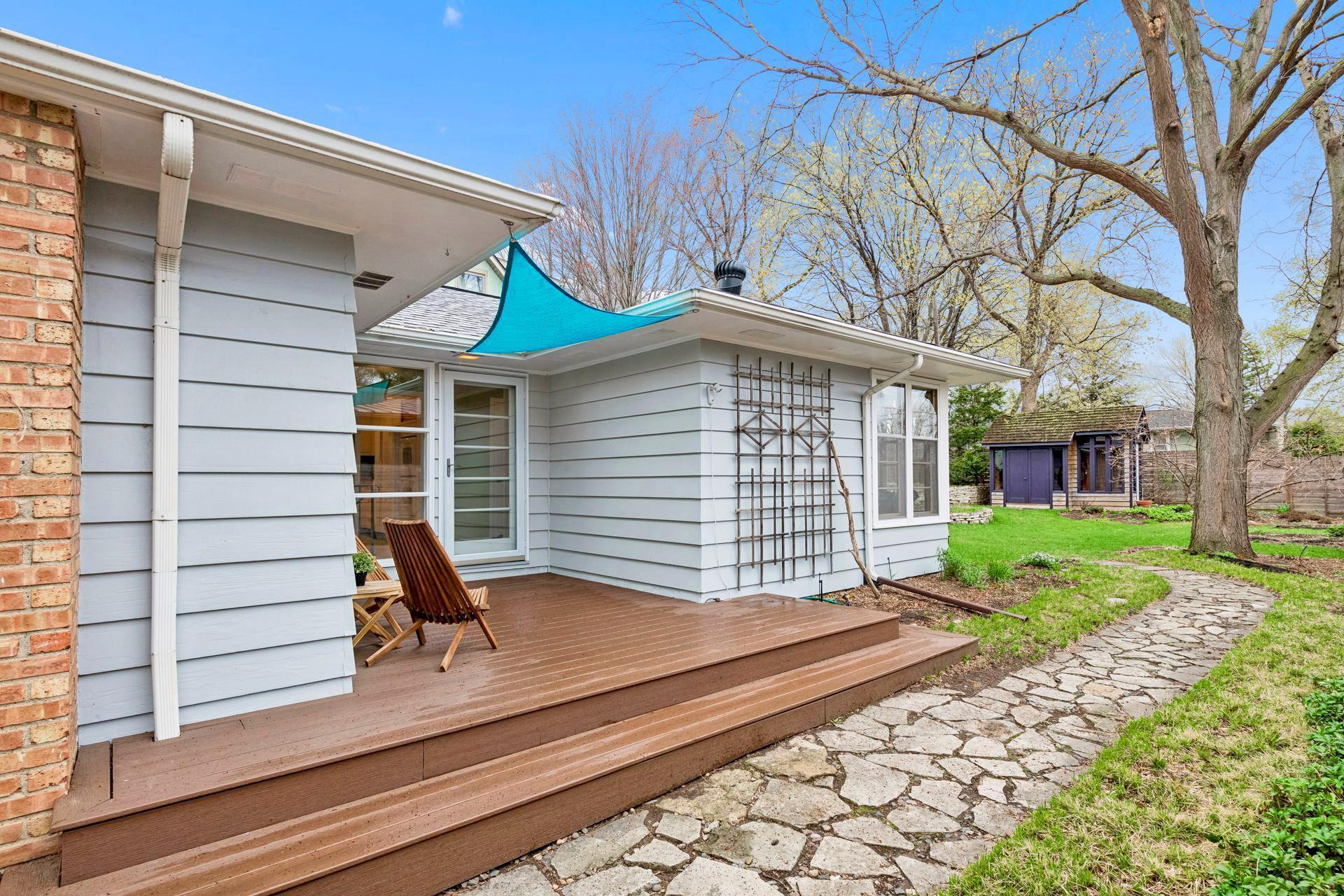The fully fenced yard has mature trees, plentiful gardens and a charming storage shed.