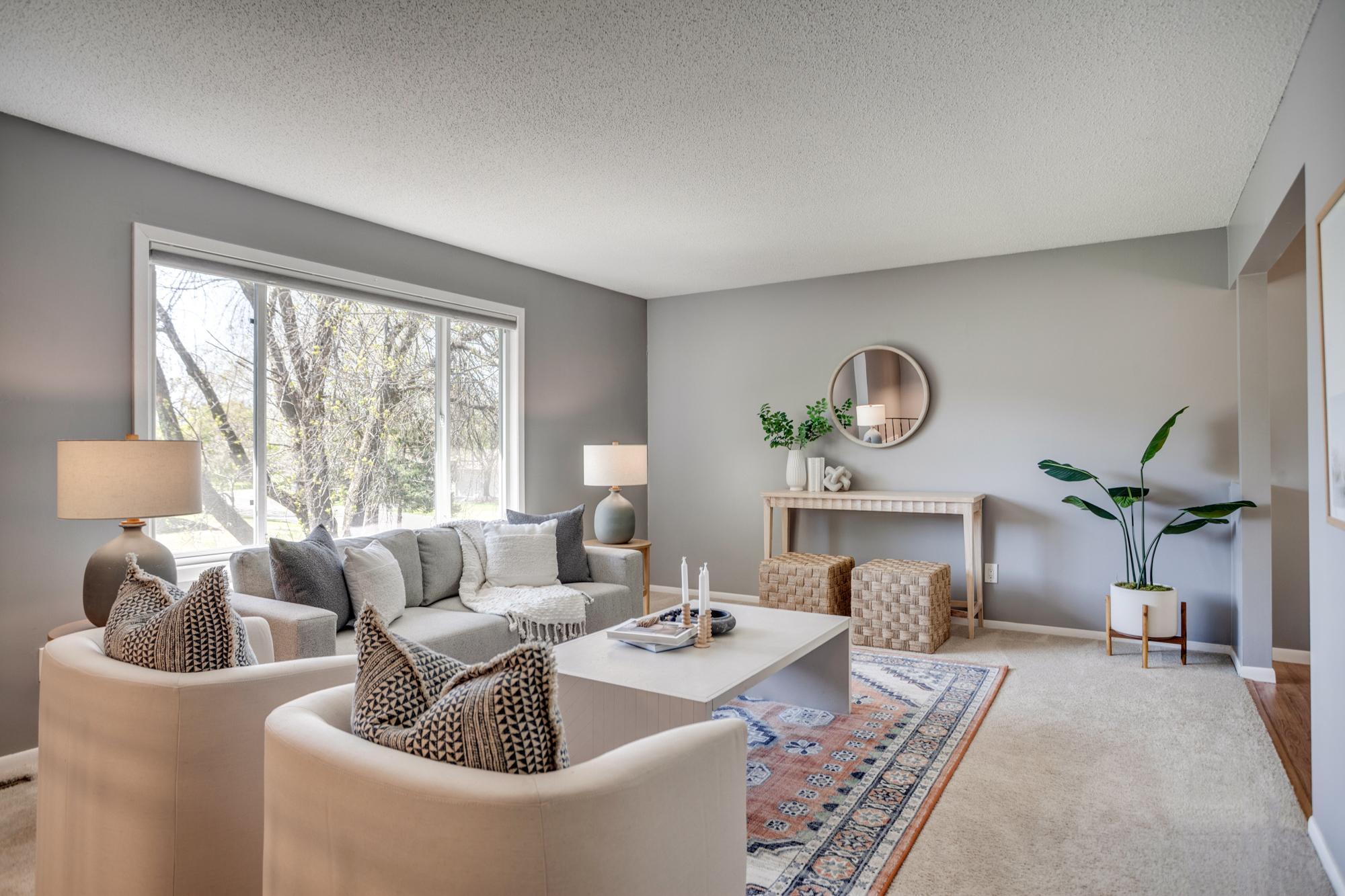The main level features a sunny living room that flows into the dining room and kitchen