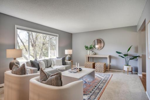 The main level features a sunny living room that flows into the dining room and kitchen