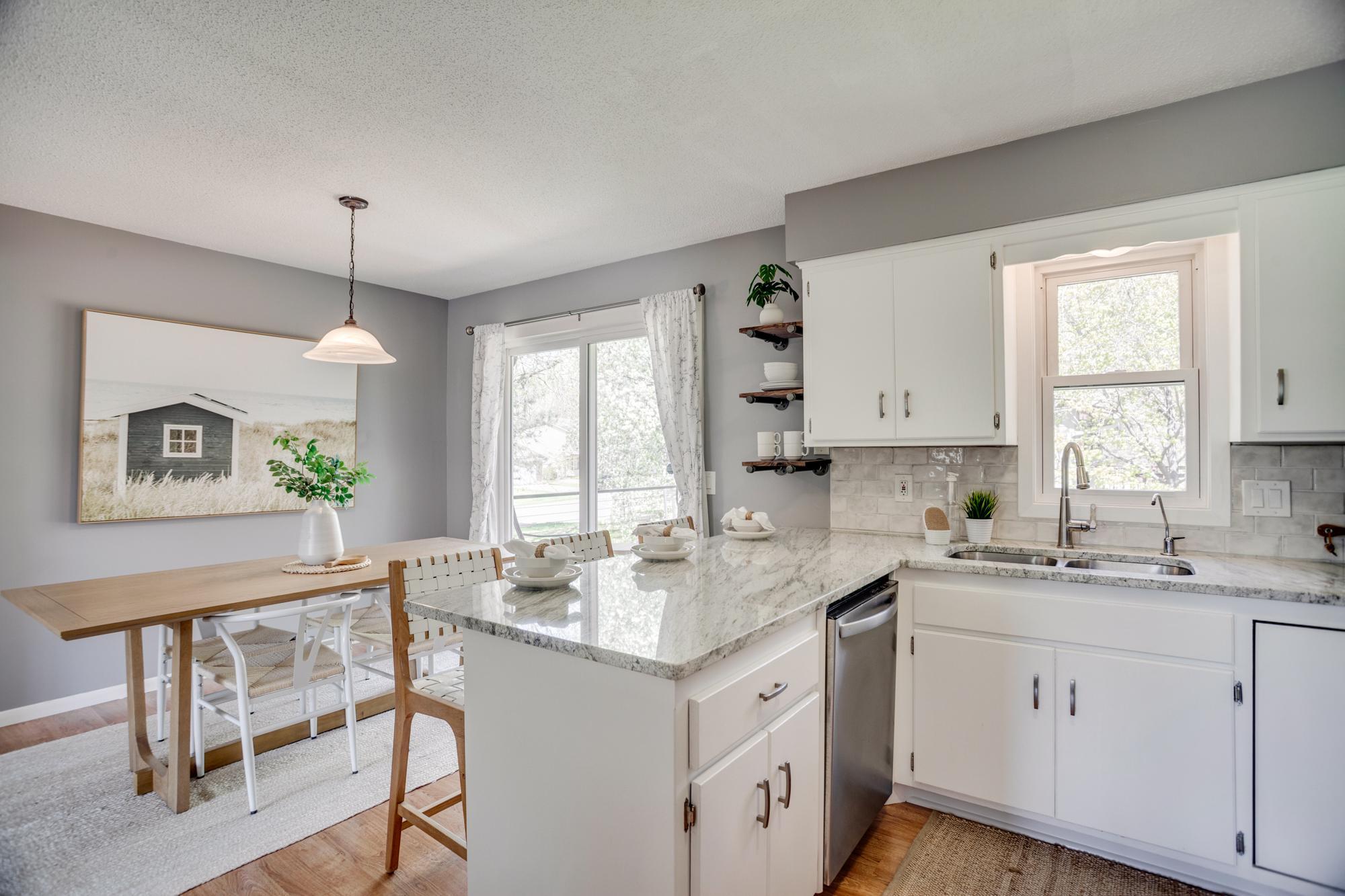 The dining area overlooks the backyard and includes a breakfast bar with seating