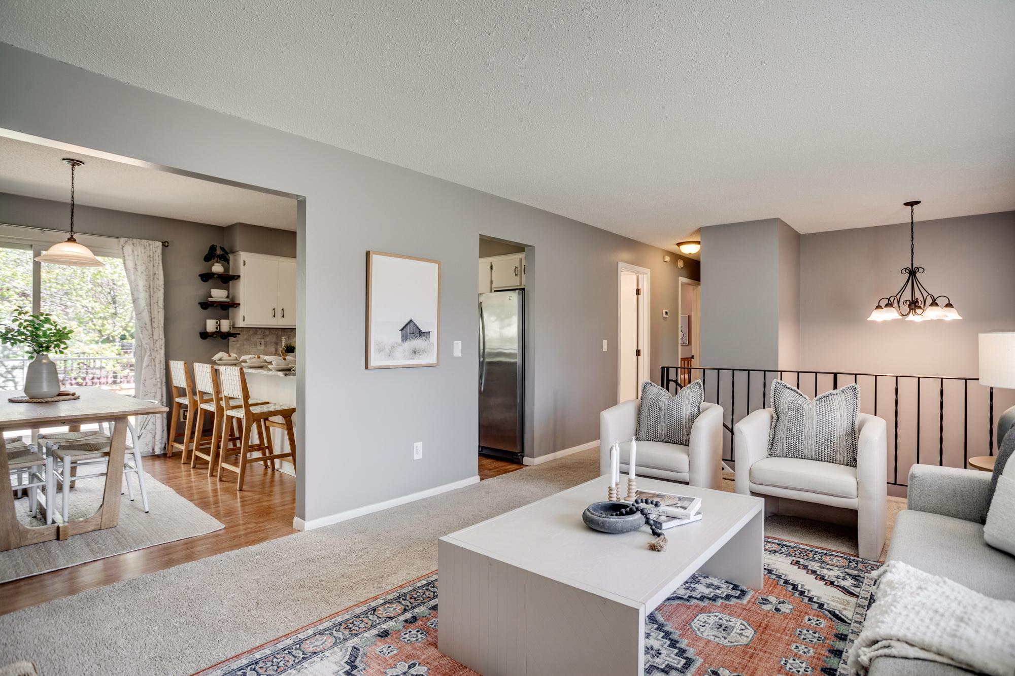 The main level features a sunny living room that flows into the dining room and kitchen