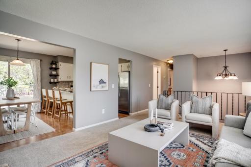 The main level features a sunny living room that flows into the dining room and kitchen