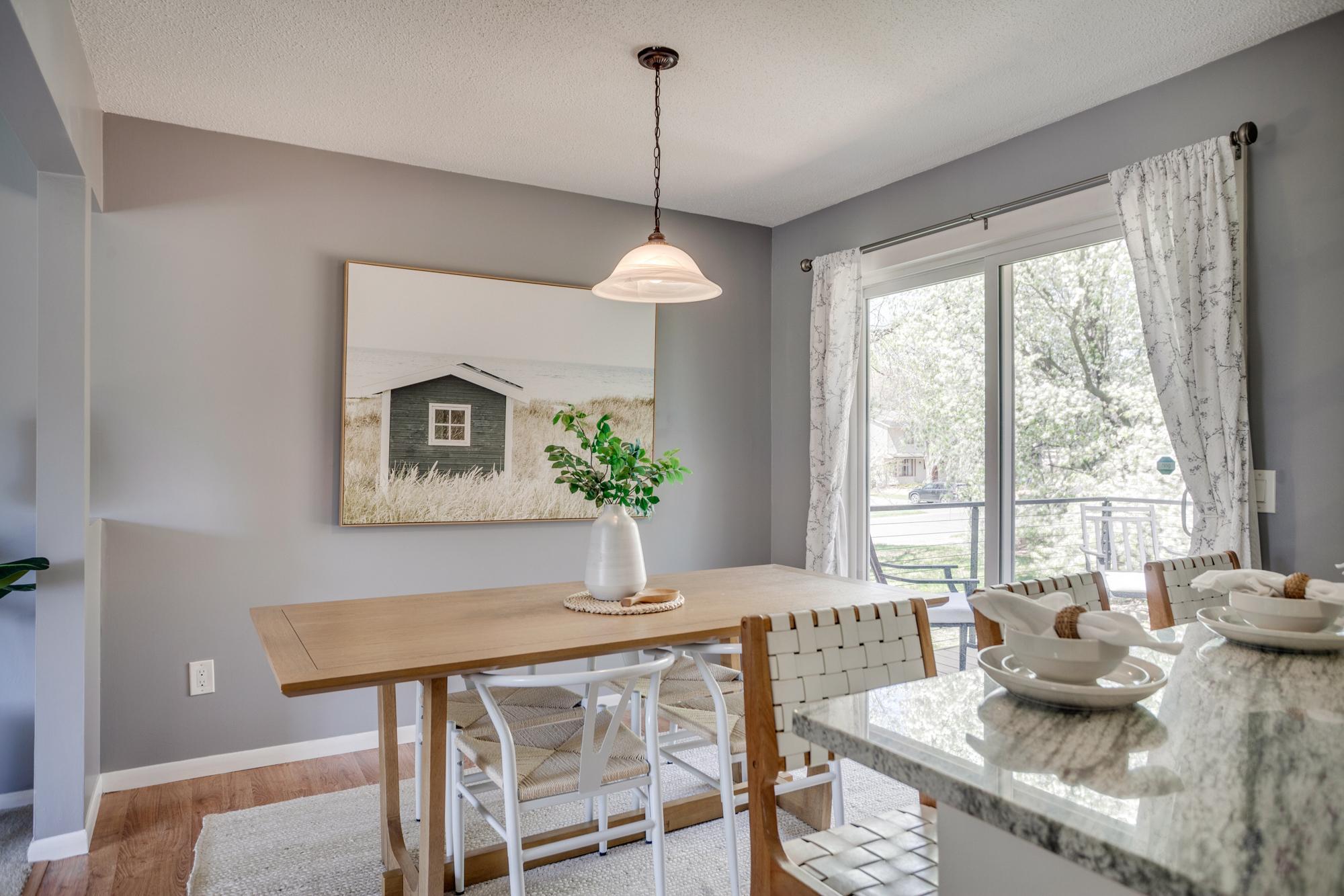 The dining area overlooks the backyard and includes a breakfast bar with seating