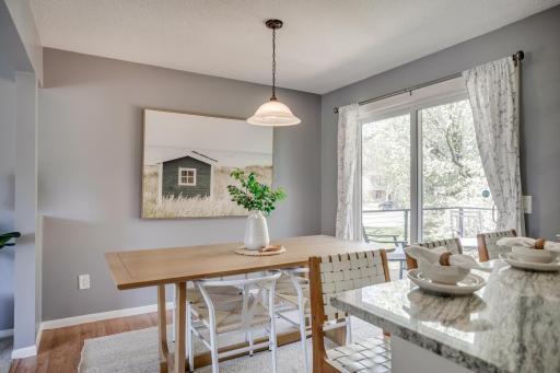 The dining area overlooks the backyard and includes a breakfast bar with seating