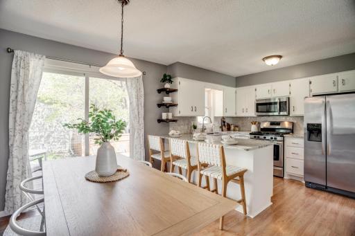 The recently updated kitchen features tile backsplash, granite countertops and stainless-steel appliances