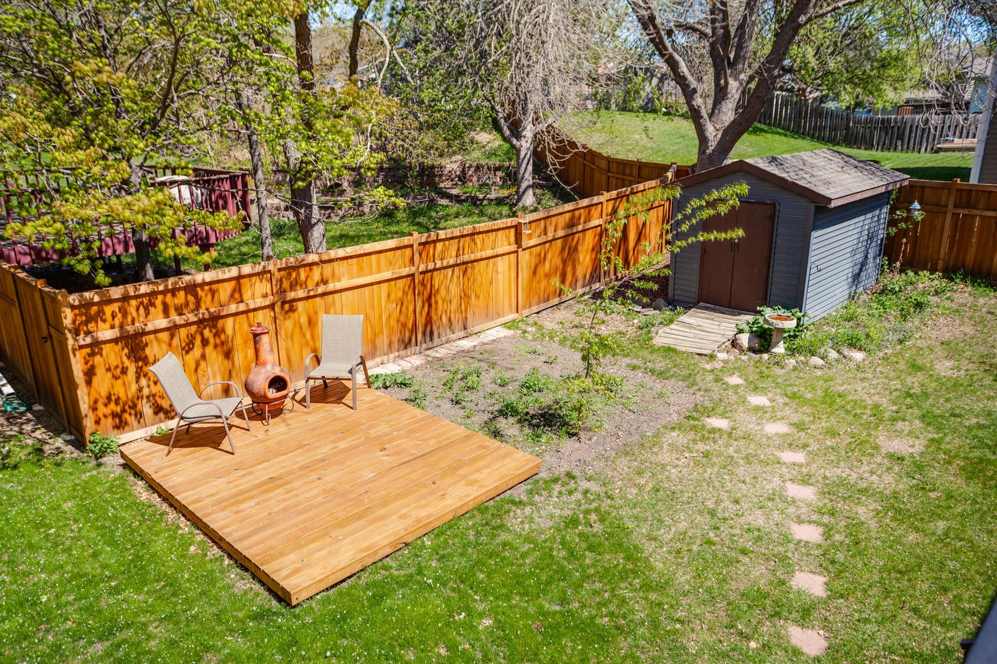 The generously sized yard has something for everyone with two decks, wildflower gardens, a fire pit, storage shed, and cedar privacy fencing