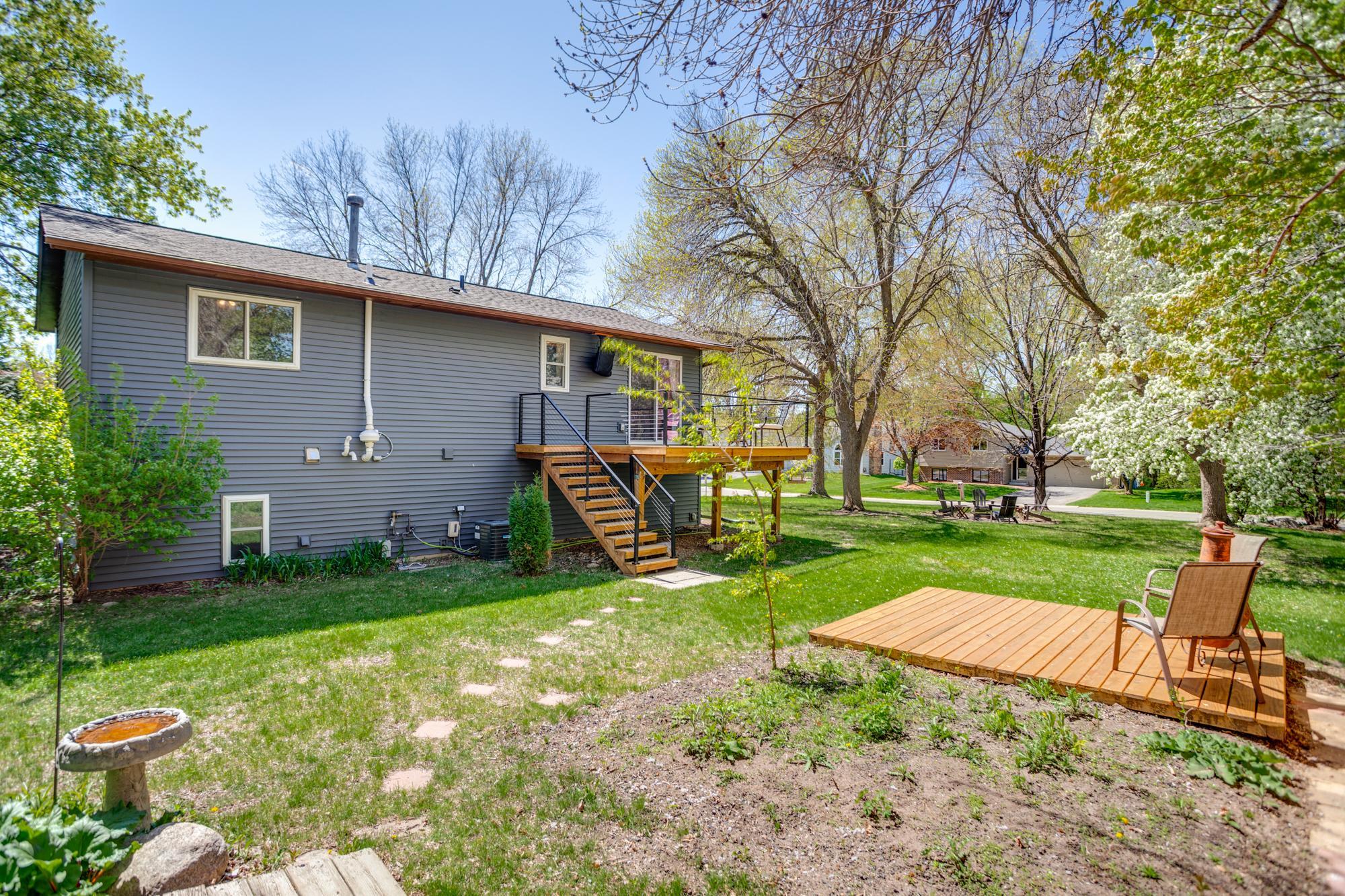 The generously sized yard has something for everyone with two decks, wildflower gardens, a fire pit, storage shed, and cedar privacy fencing