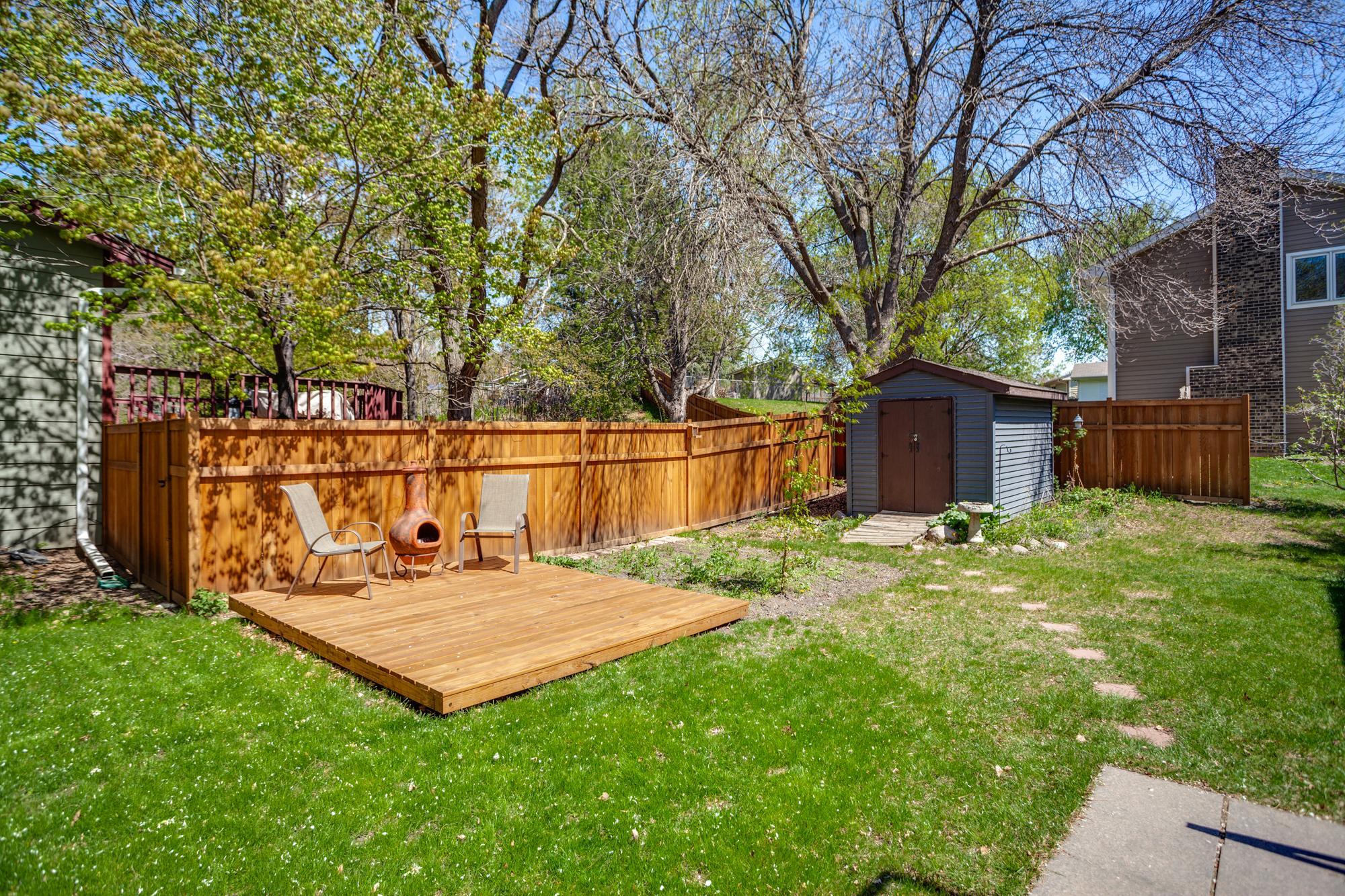 The generously sized yard has something for everyone with two decks, wildflower gardens, a fire pit, storage shed, and cedar privacy fencing