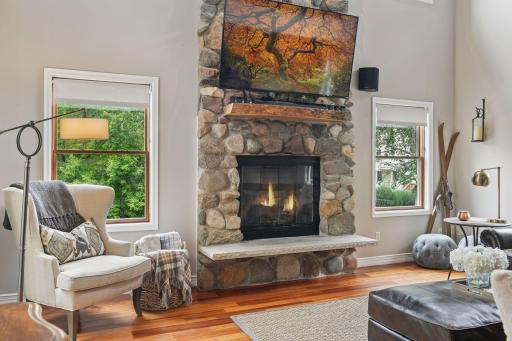 Architectural details of the great room include a floor-to-ceiling field stone fireplace and wet bar.