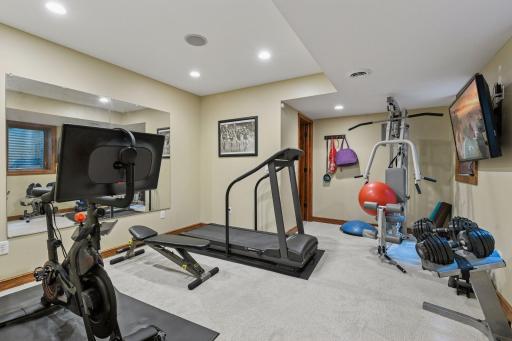 The fourth bedroom in the lower level is staged as a home gym.