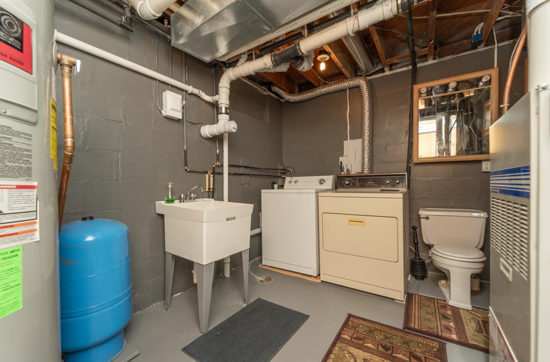 Updated laundry area with new tub and plumbing improvements.