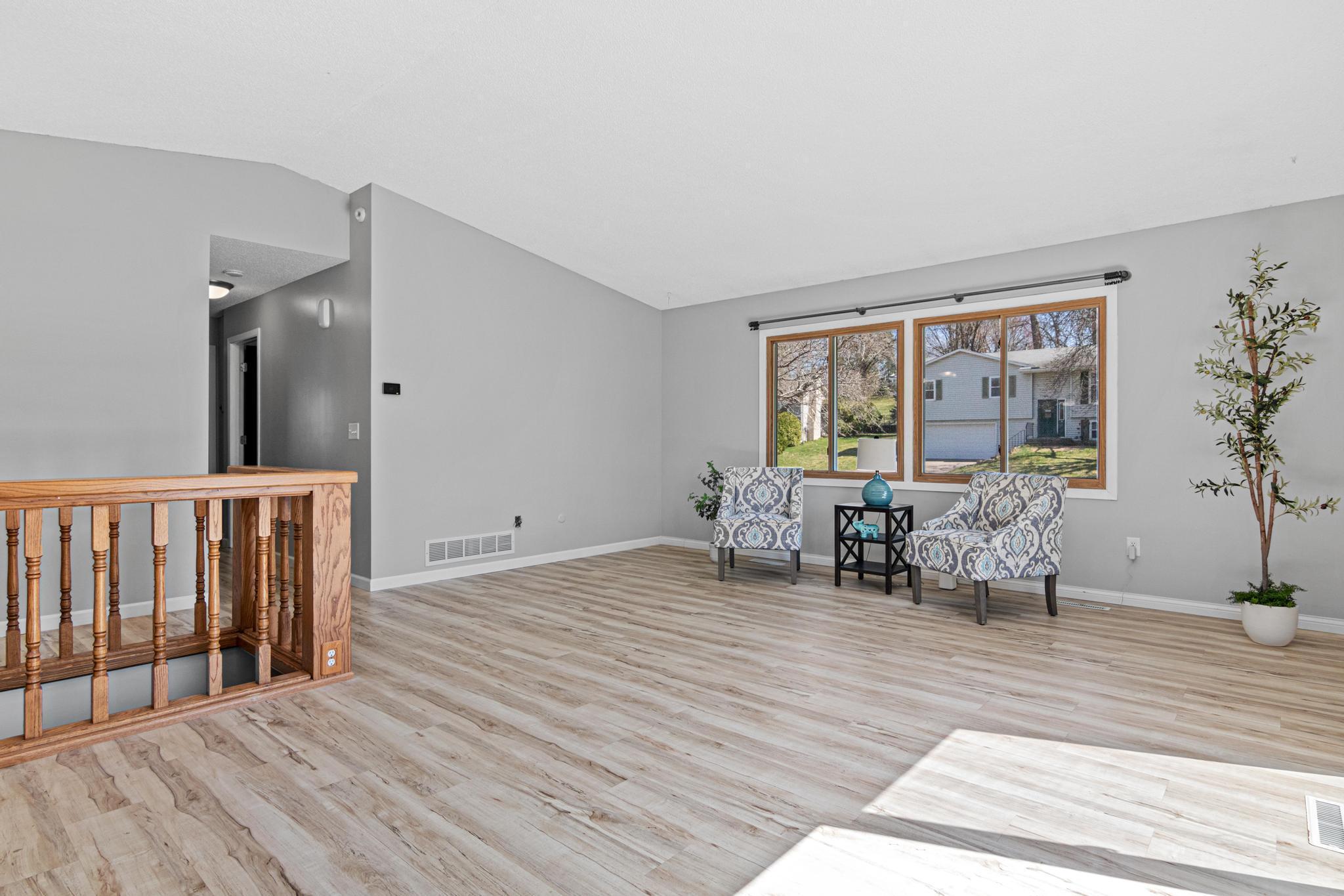 Light-filled living space with fresh paint and an inviting layout for everyday living or entertaining. New paint throughout and newer LVP flooring.
