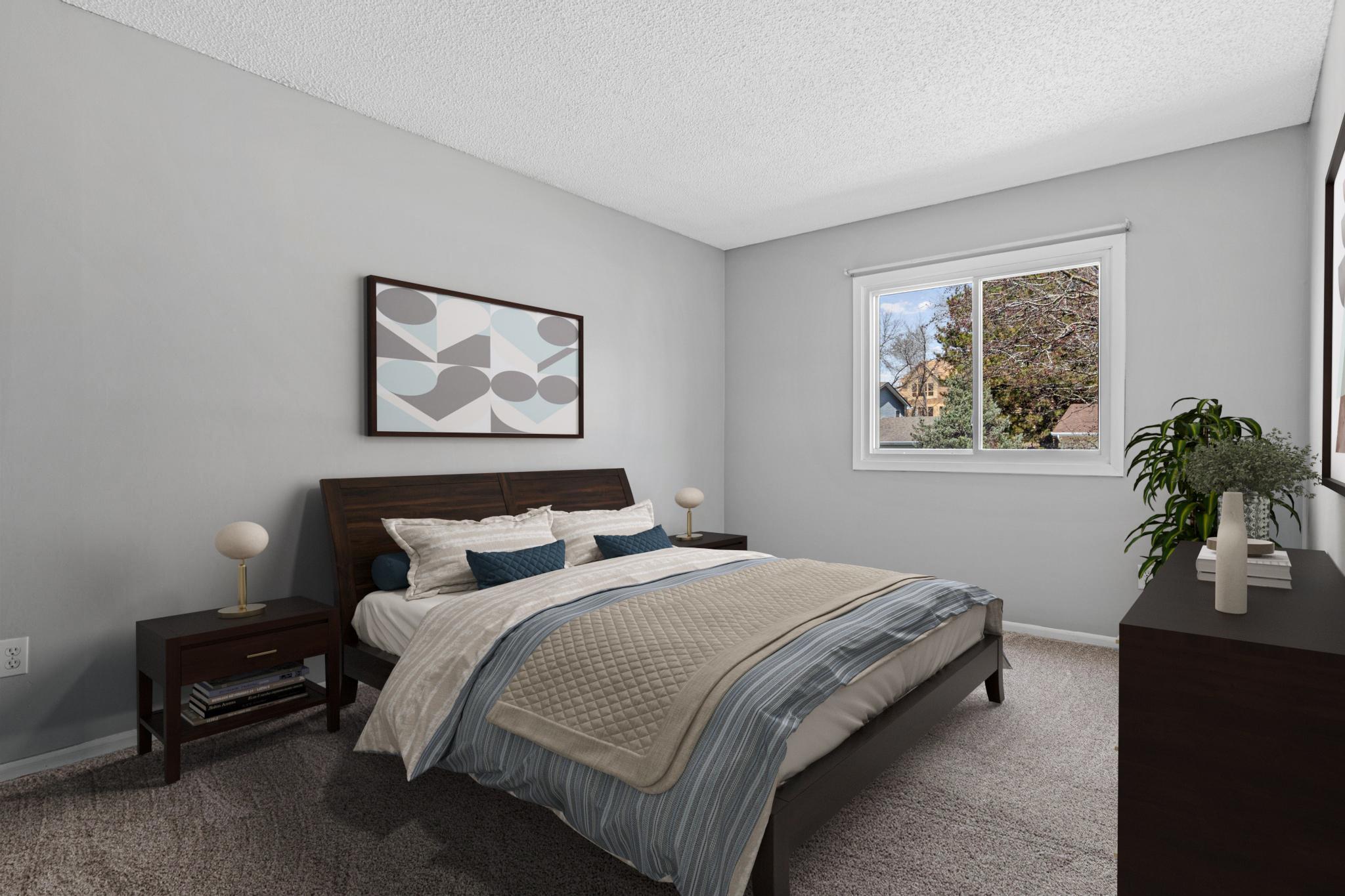 Visually staged bedroom- one of three on the main level. Fresh paint, newer carpet and window.