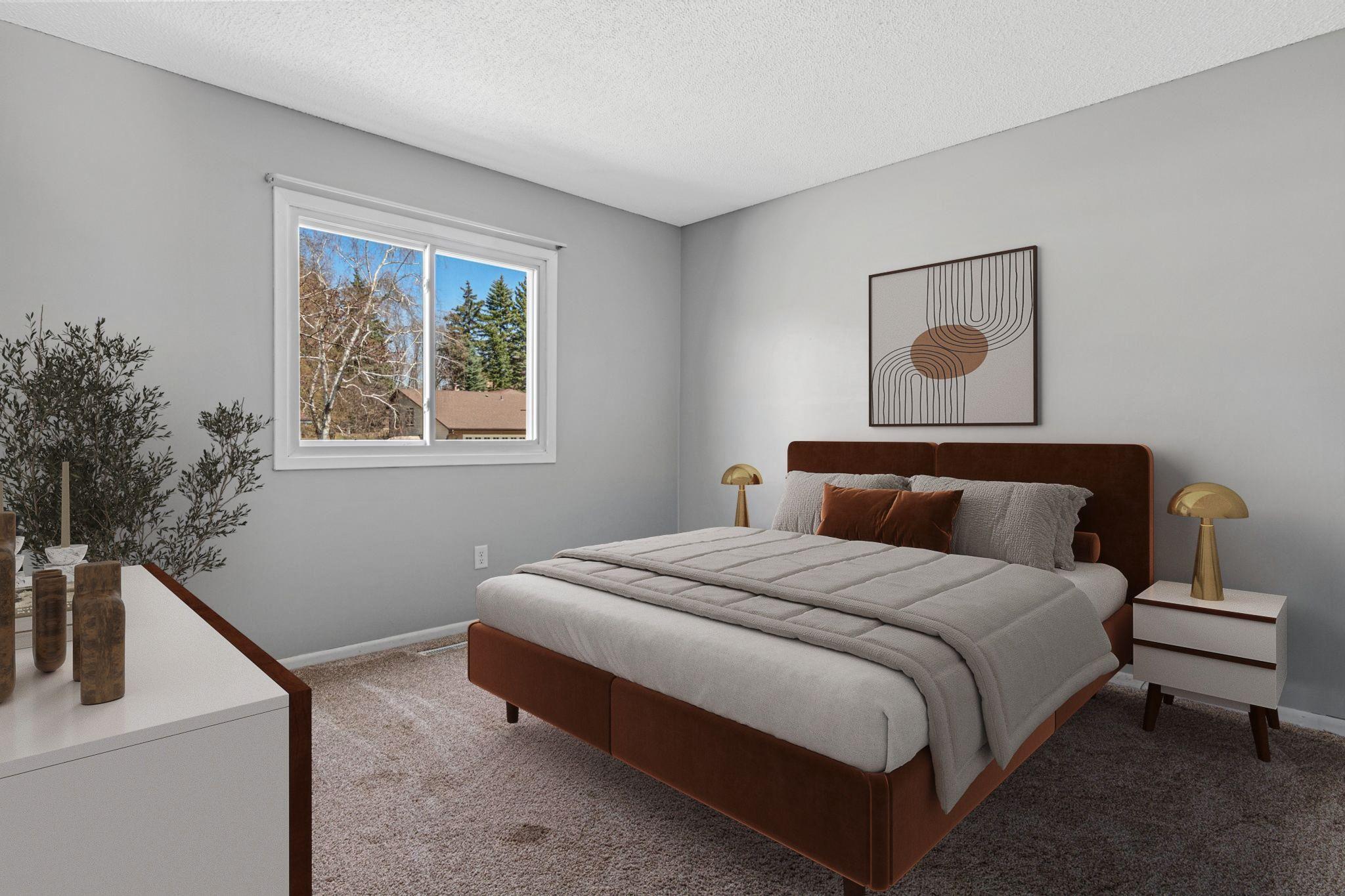 One of three bedrooms on the main level- this overlooks the front yard. New paint and newer carpet. Visually staged.