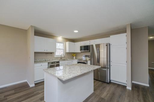 Kitchen features new stainless steel appliances, Granite countertops, enameled woodwork w/ brushed nickel hardware and LVP flooring.